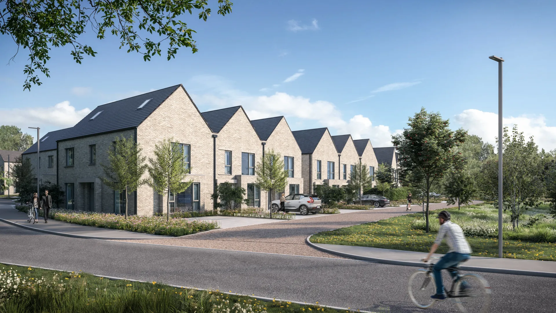 A row of modern terraced houses with yellow bricks, and large landscaped areas