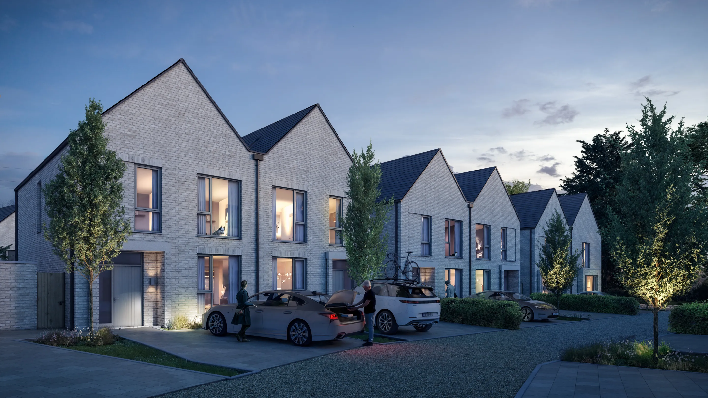 A row of modern yellow bricked terraced houses with cars on the driveway