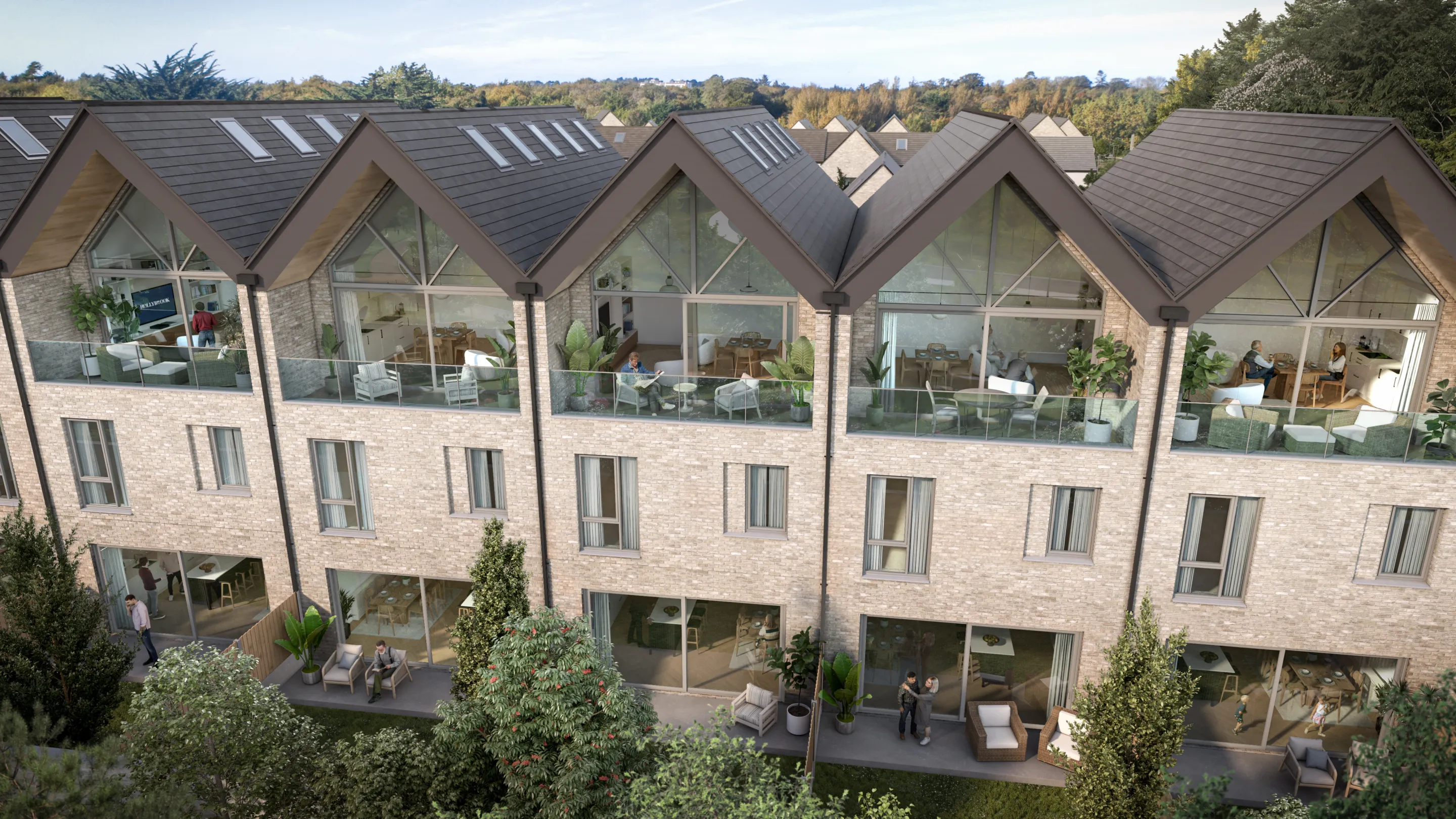 A row of modern terraced duplex apartments with large floor to ceiling height glazing and garden space