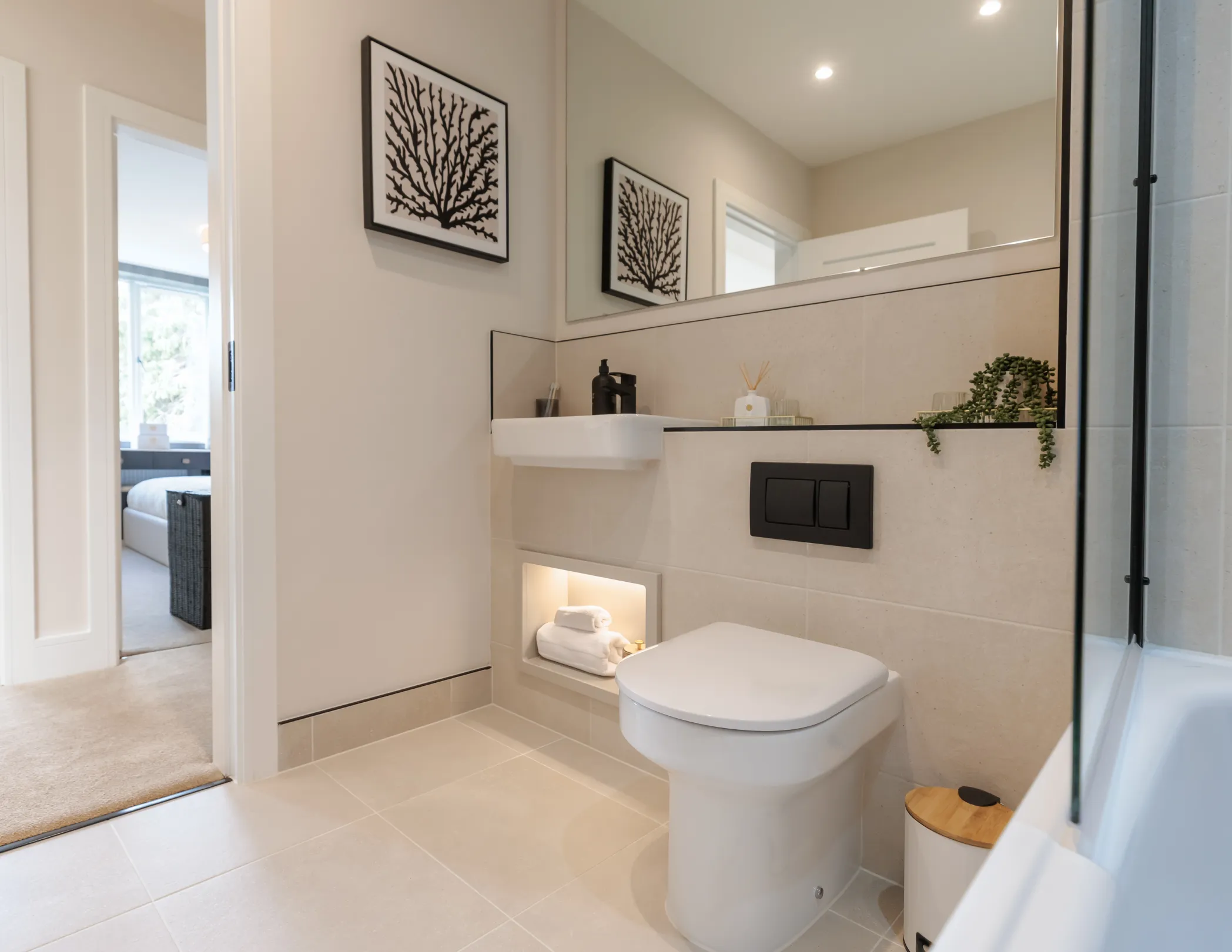 A modern bathroom featuring a toilet, sink, and decorative elements.