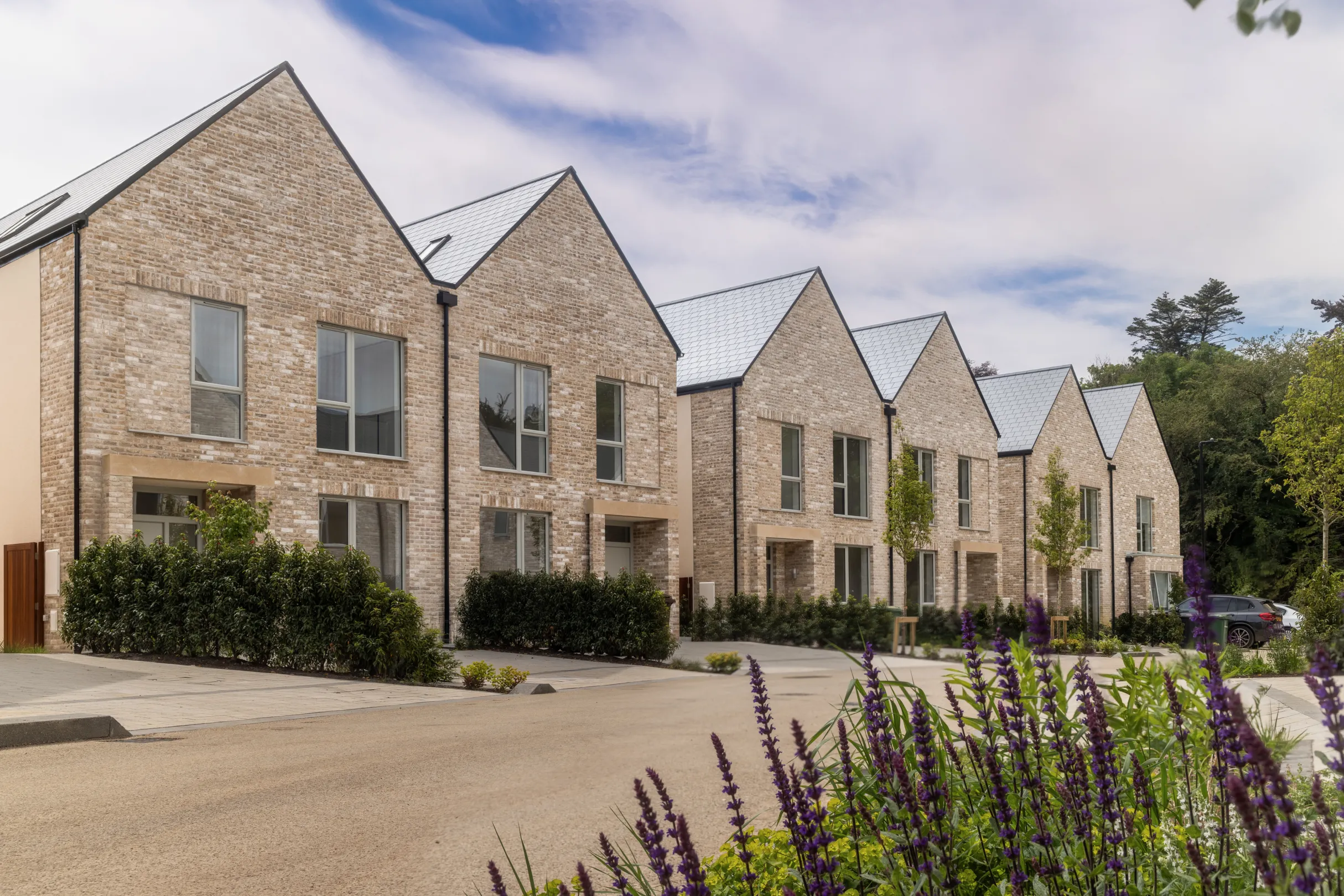A row of modern terraced houses with landscaping
