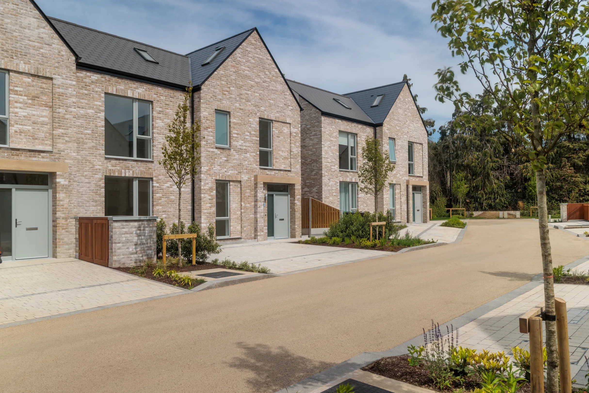 A row of modern terraced houses with landscaping