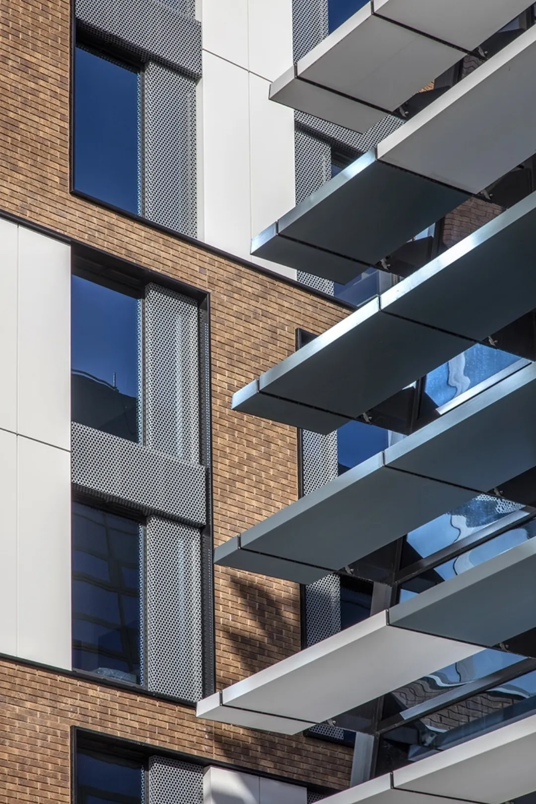 Architectural detail of solar shading with a building from the same development in the background