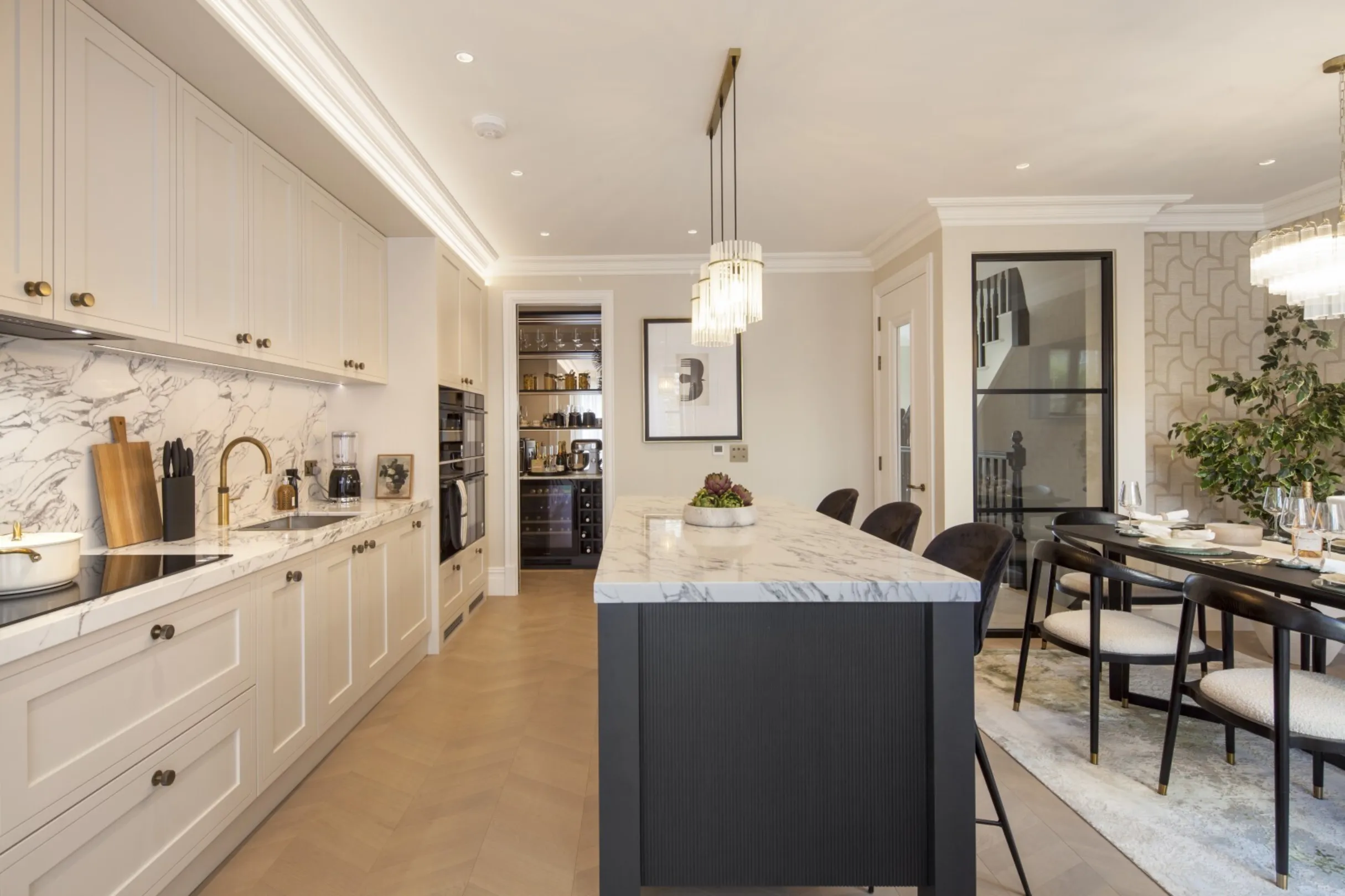 Kitchen and dining: Open-plan kitchen and dining space with a walk-in pantry and a glazed screen to the hallway.