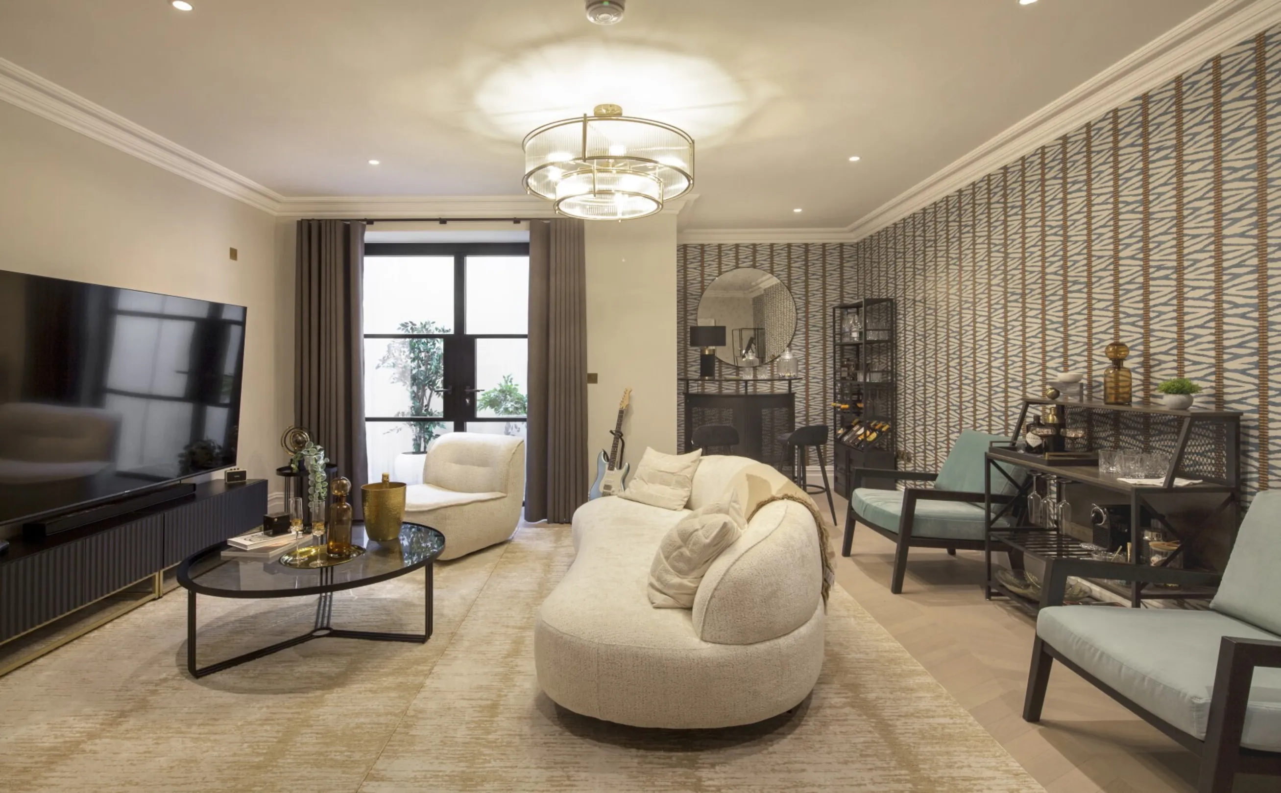 Lower-ground lounge: A relaxed media and entertaining room with a home bar and doors to a private lightwell.