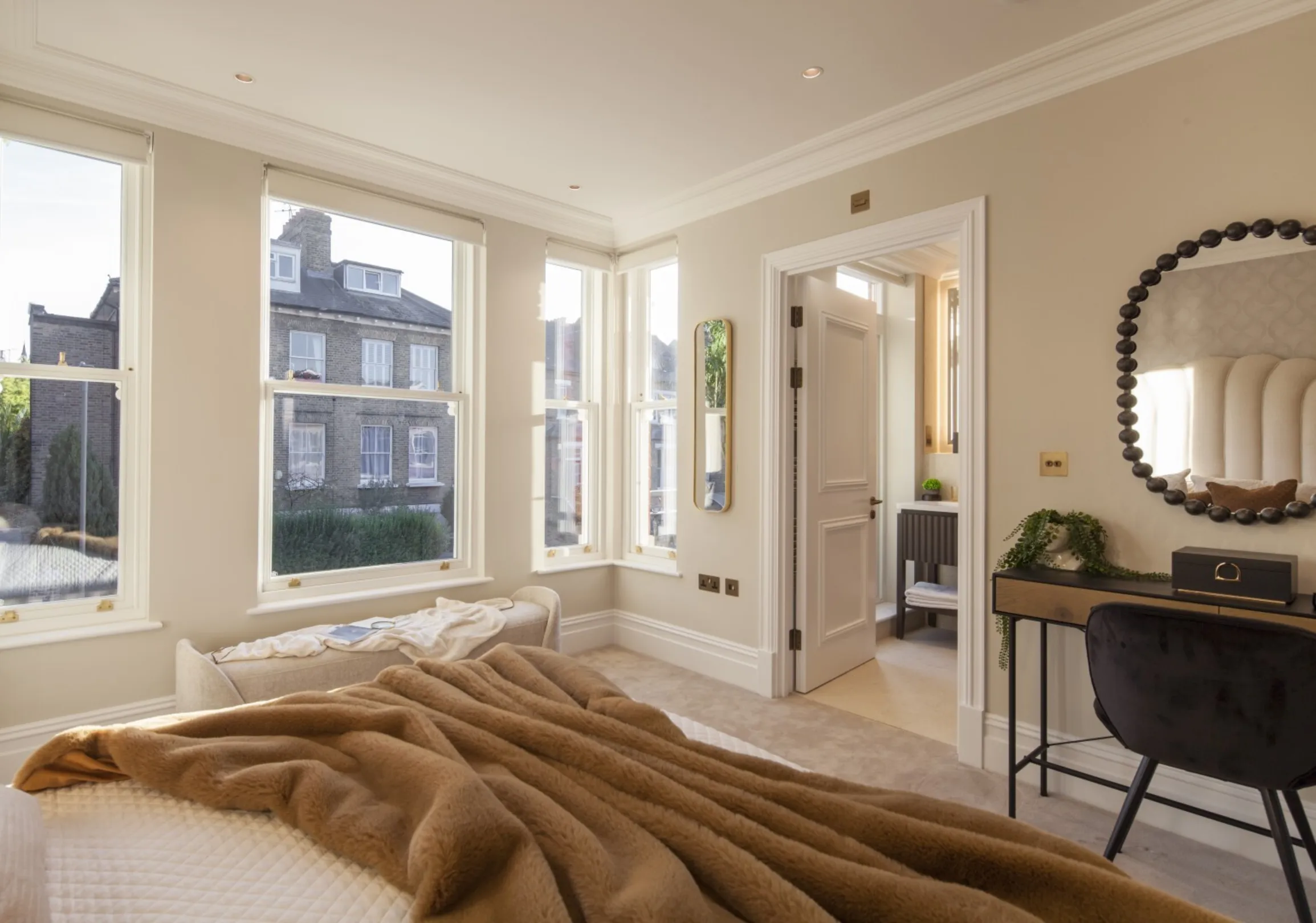 Second bedroom: A light-filled principal bedroom with sash windows overlooking a leafy residential street.