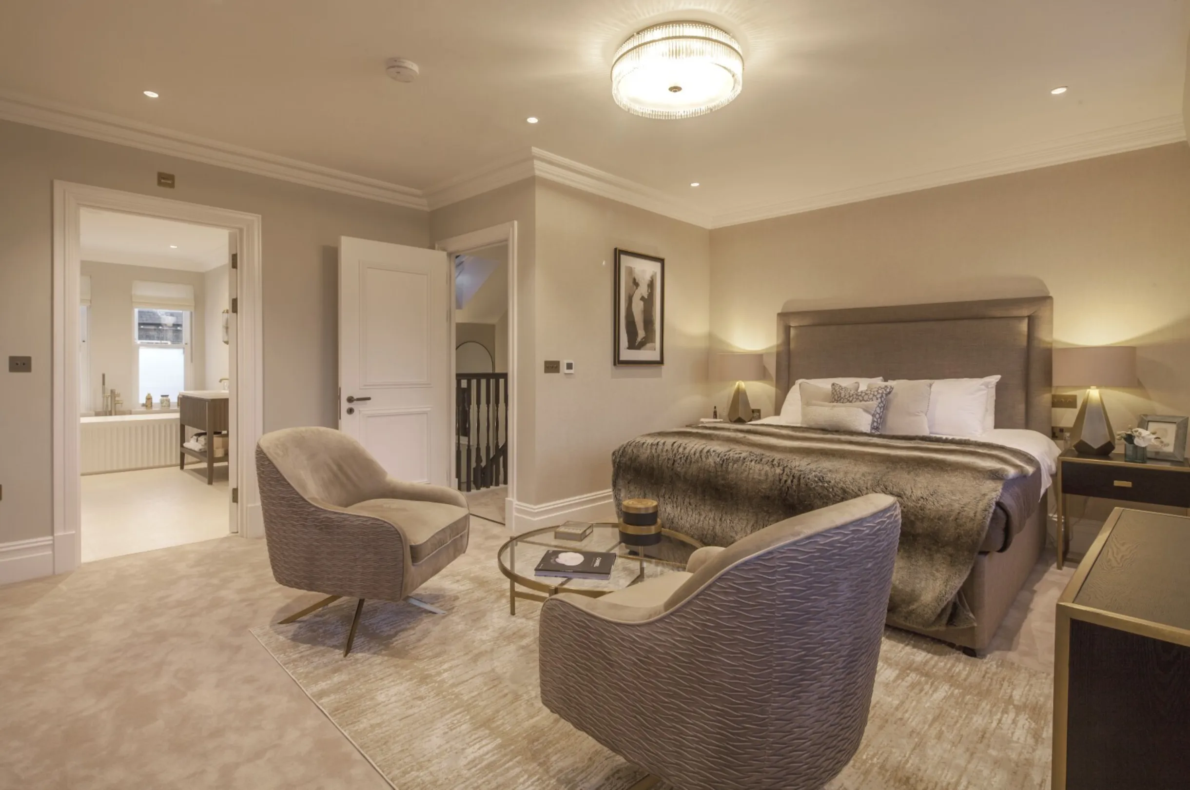 Top-floor master suite: A generous bedroom with its own seating area and direct access to the luxurious en suite bathroom with freestanding bath.