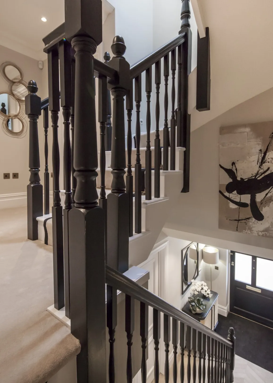 Main staircase: Traditional turned spindles in a striking dark finish rise through the home, with views down to the entrance hall below.