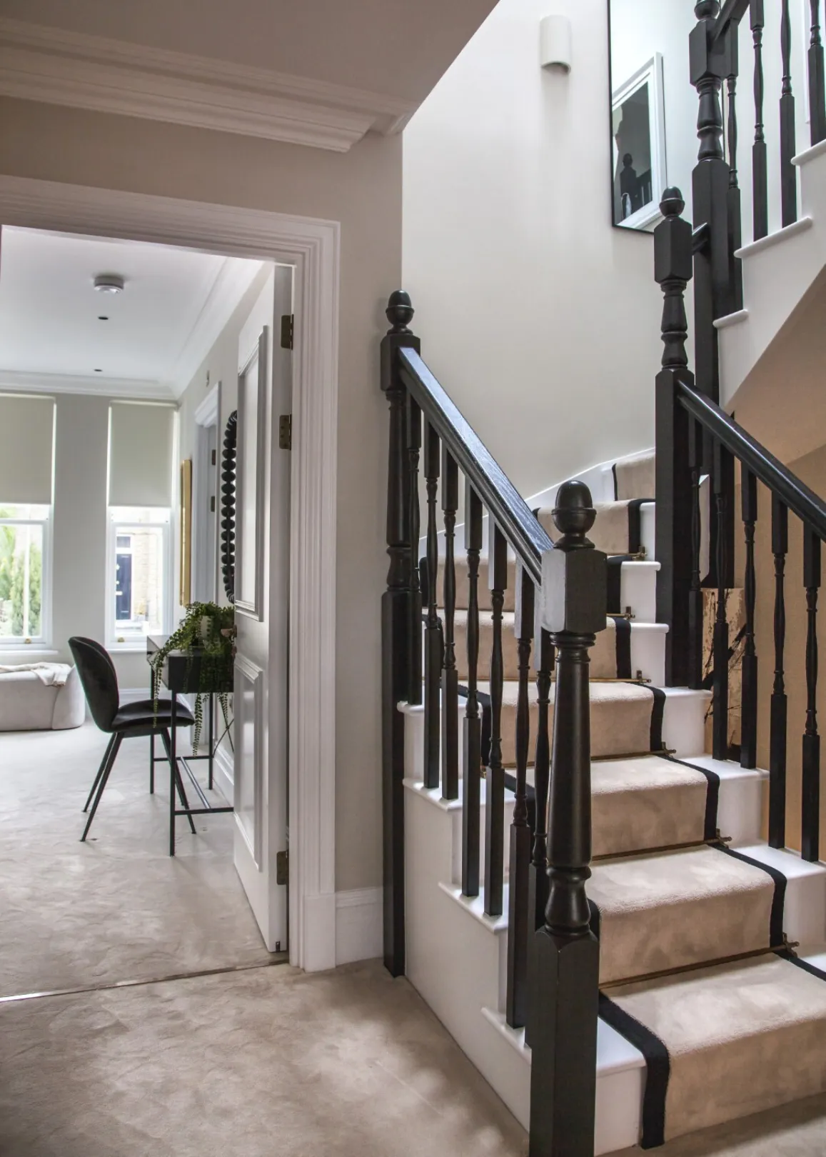 First-floor landing: A bright landing with a brass-rodded stair runner opens onto a light-filled double bedroom with dressing area.