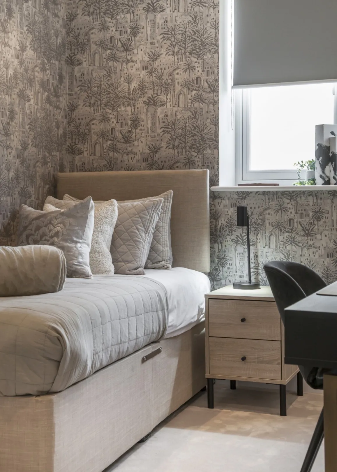 Fourth bedroom: Characterful palm-print wallpaper and a built-in study corner make this cosy single bedroom ideal for a child, guest or home office.