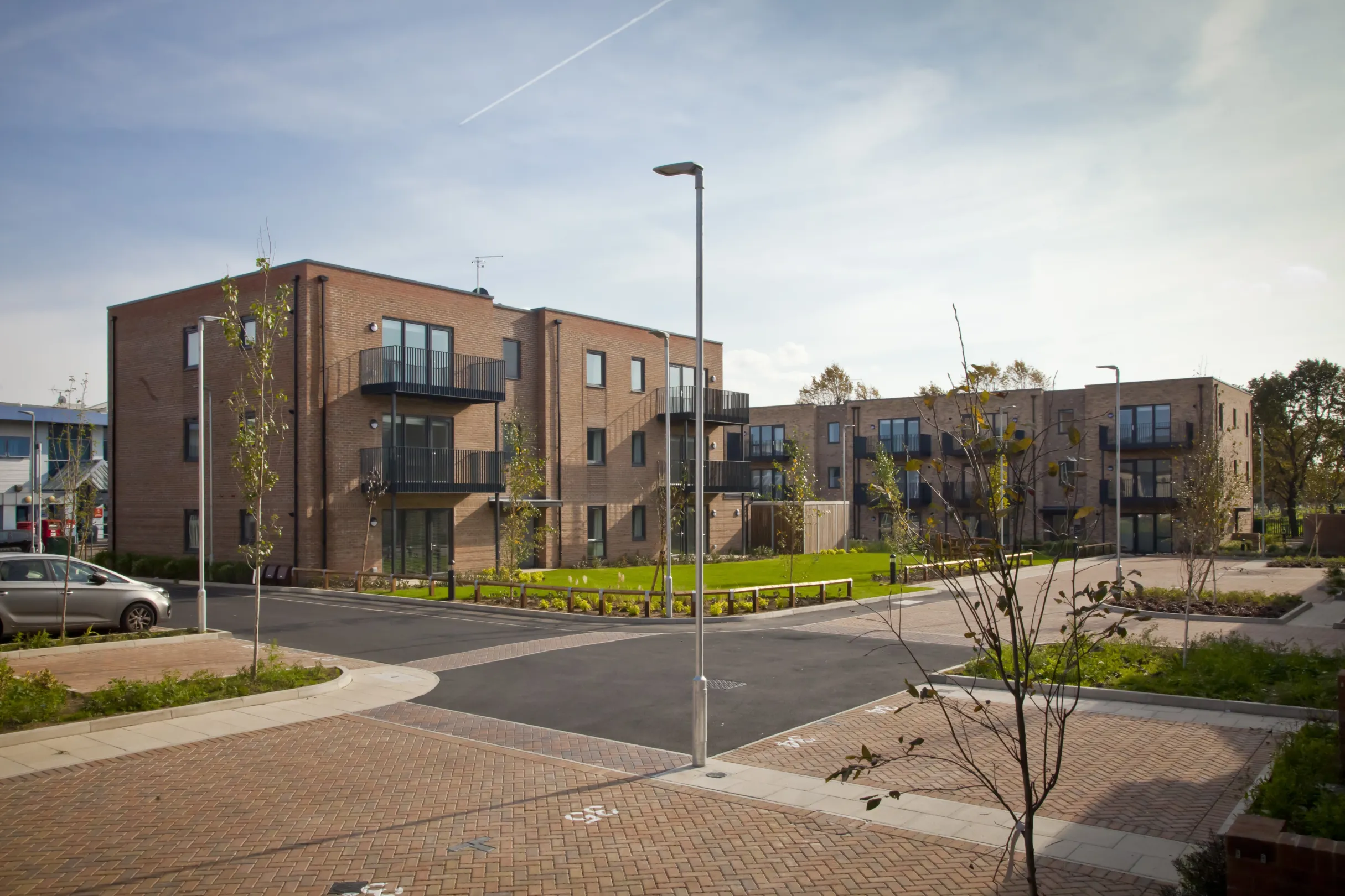 Modern low-rise flats in a residential development overlooking a central green space