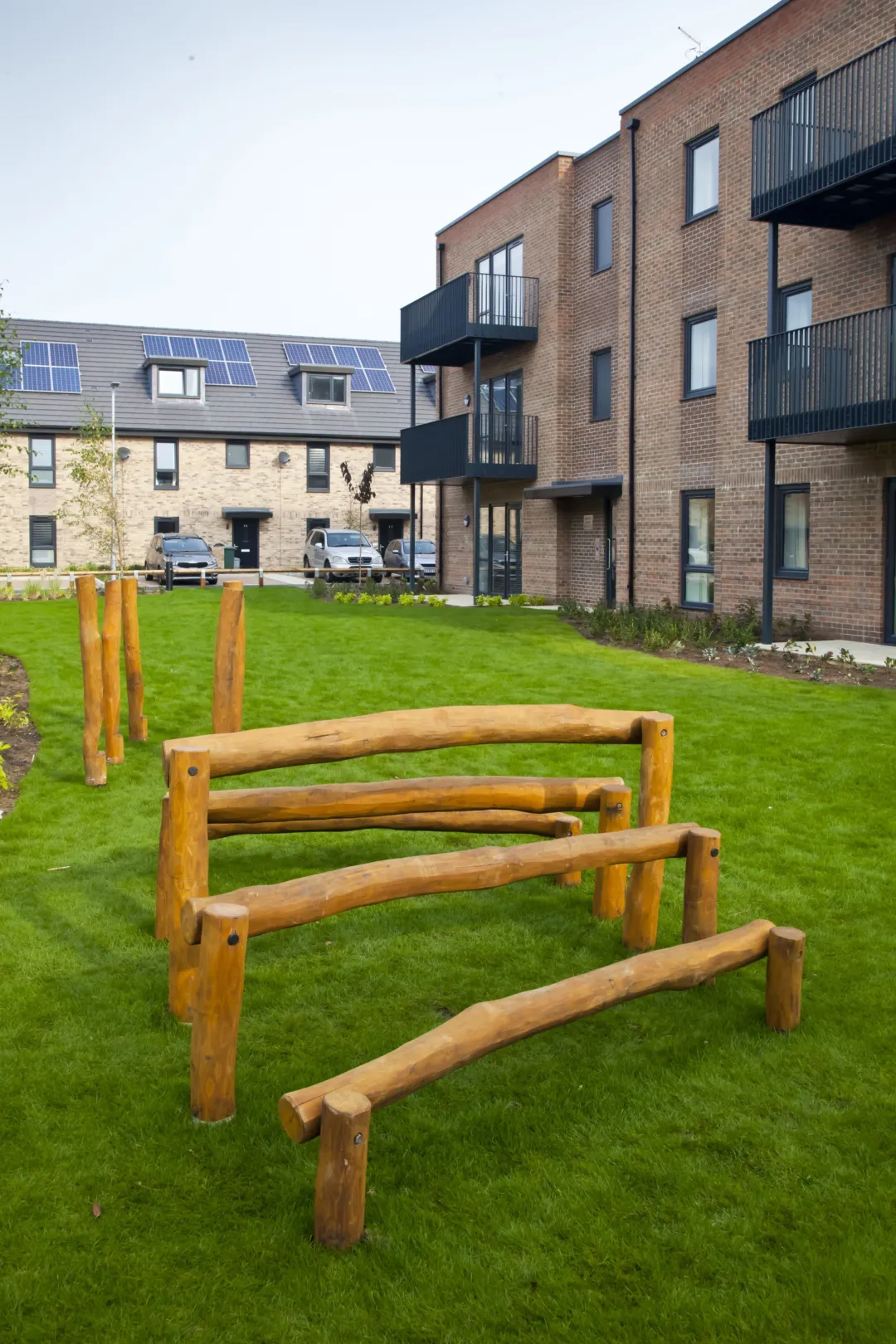 Modern flats low-rise flats overlook a communal green space at the centre of a residential development