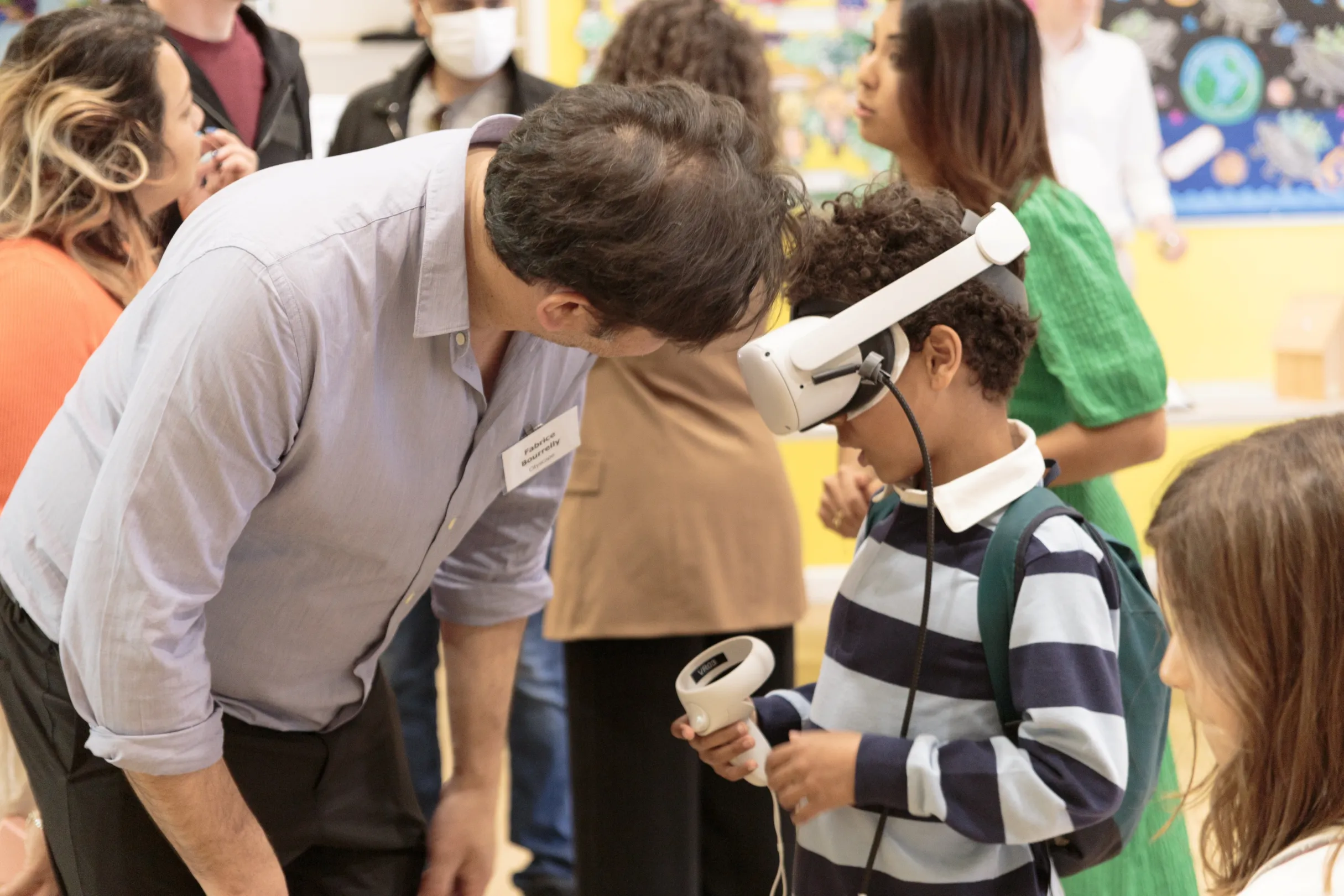 A child wearing a VR headset at a public consultation in a local community hall