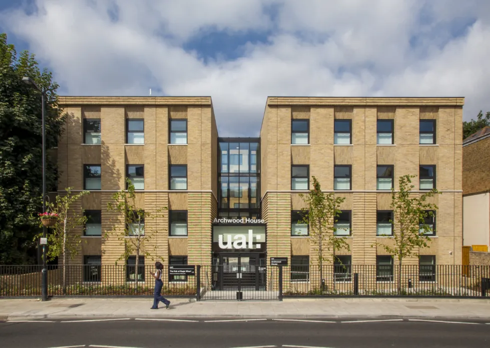 Facade of a modern four story building with central glazed atrium. A prominent sign above the door reads: Archwood House UAL
