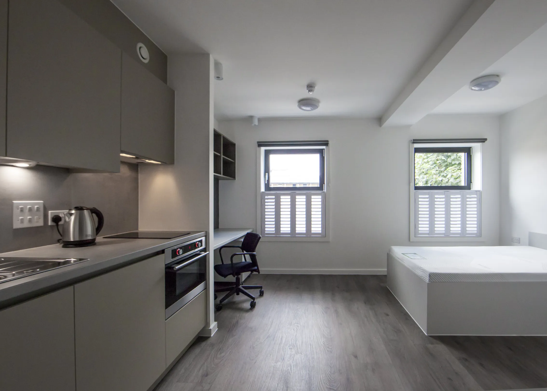 Kitchen, bed and study area in student accomodation