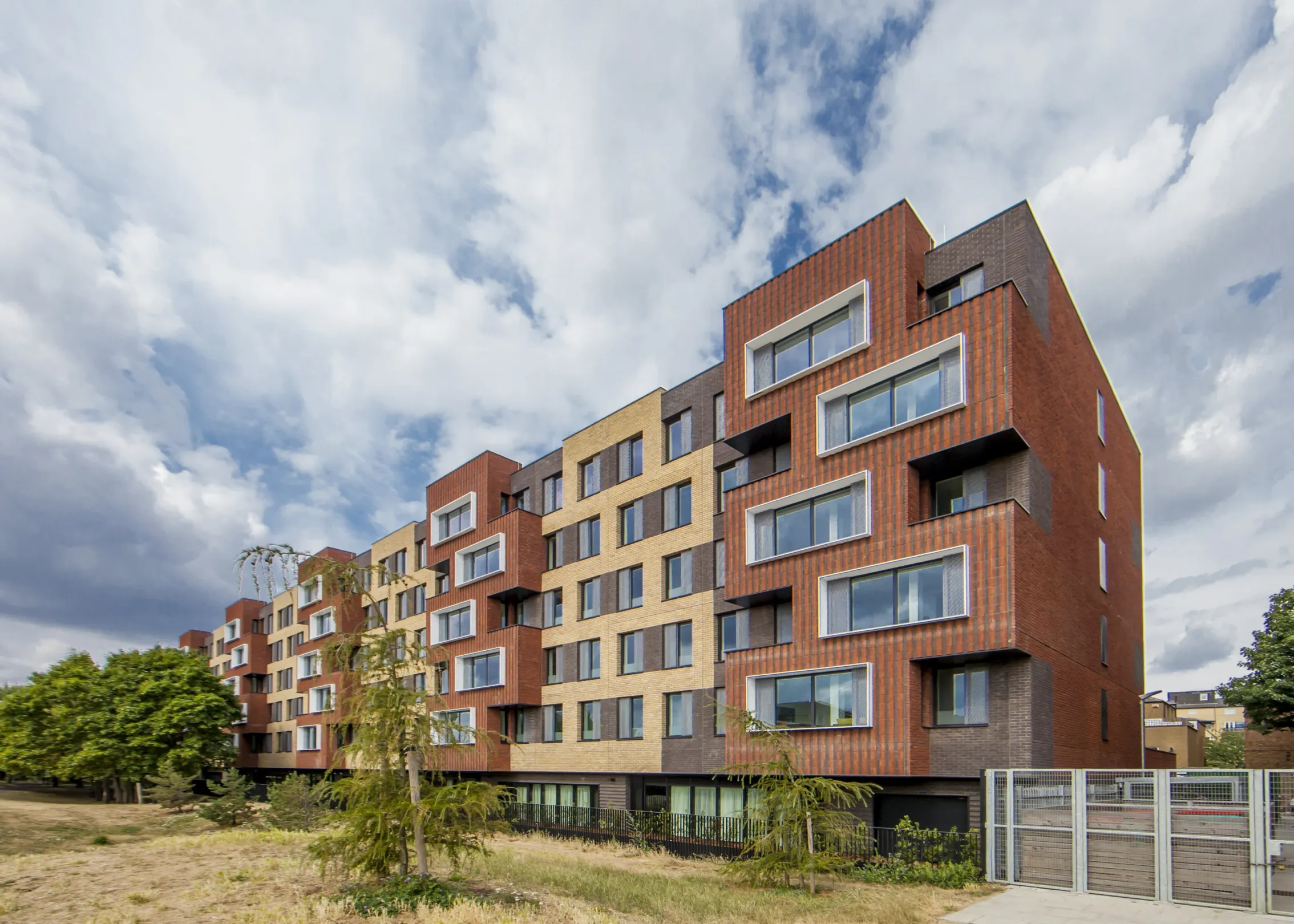 Modern six storey building in two tones of brick and modulating facade