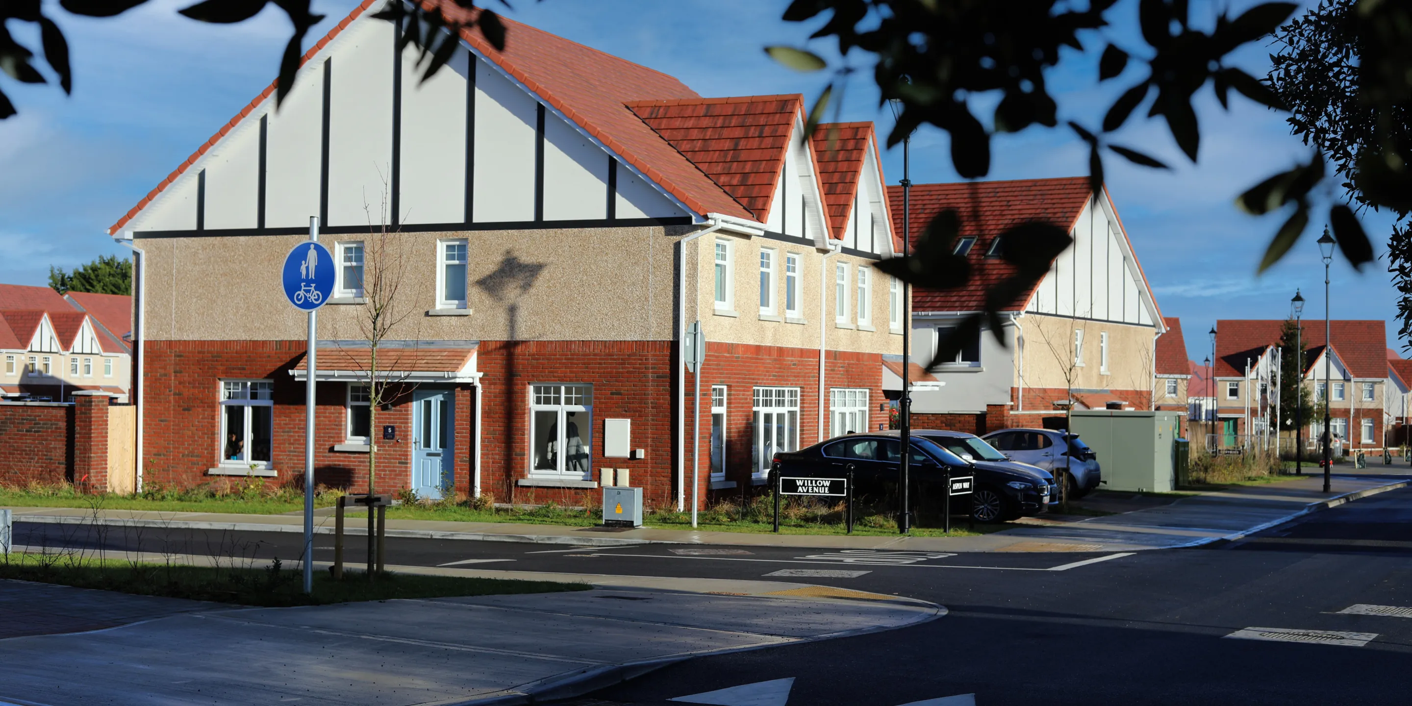 A row of traditional terraced houses on a new housing estate wiith pitched roofs