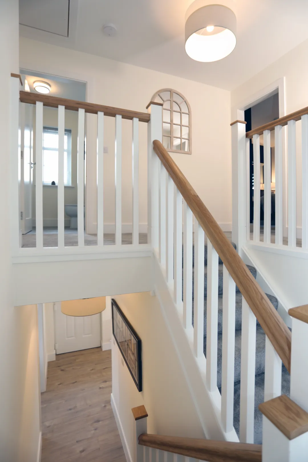 A timber staircase going from ground floor to the first floor with bedrooms at the top of the stairs
