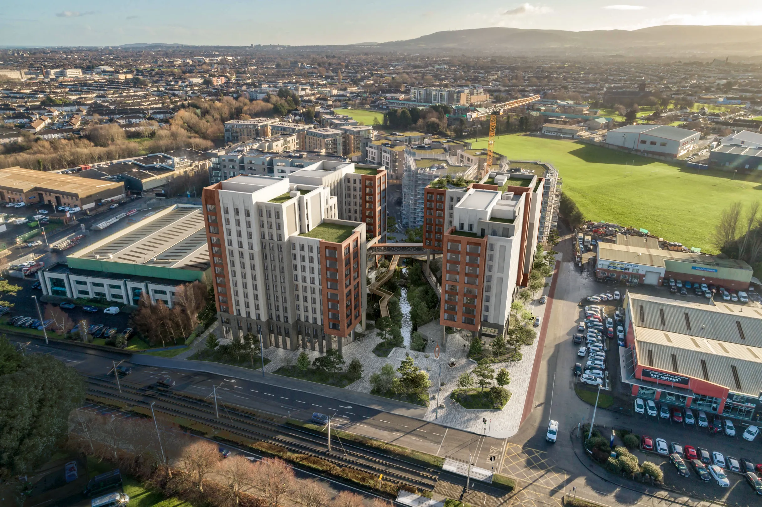 An aerial CGI image of a large new build student accommodation development with green roofs, bridge through the centre over an eco pool