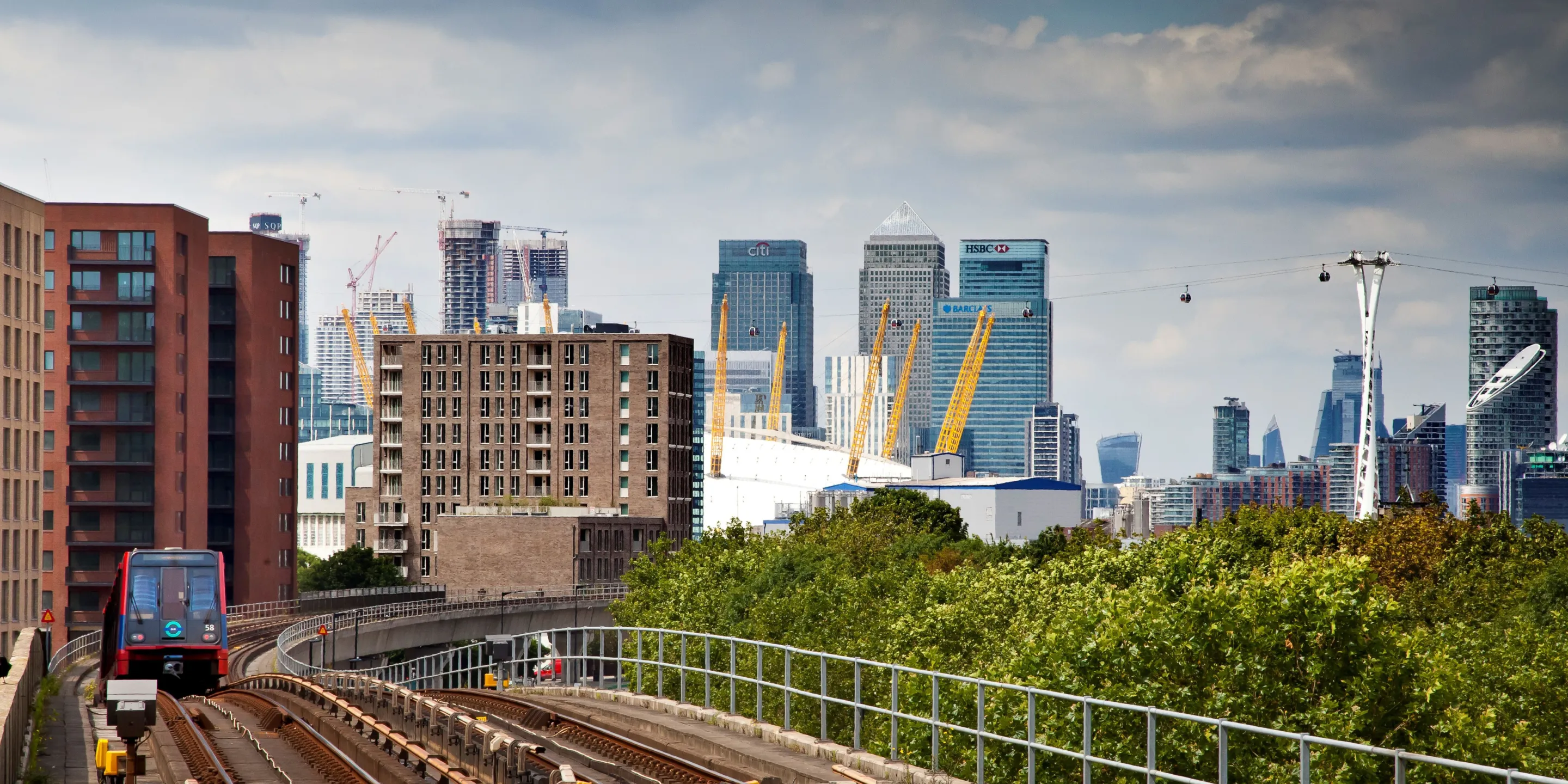 View of a new build development in the distance, with the O2 and Canary Wharf in the background