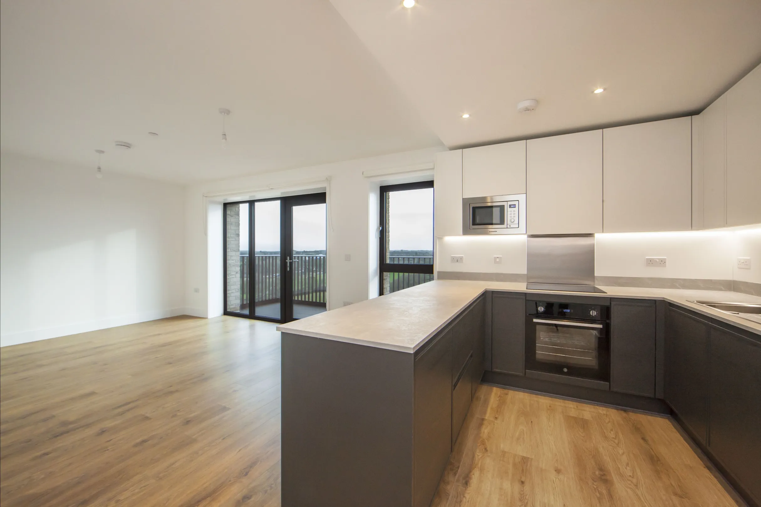 A modern kitchen/living area with views to the countryside from the balcony