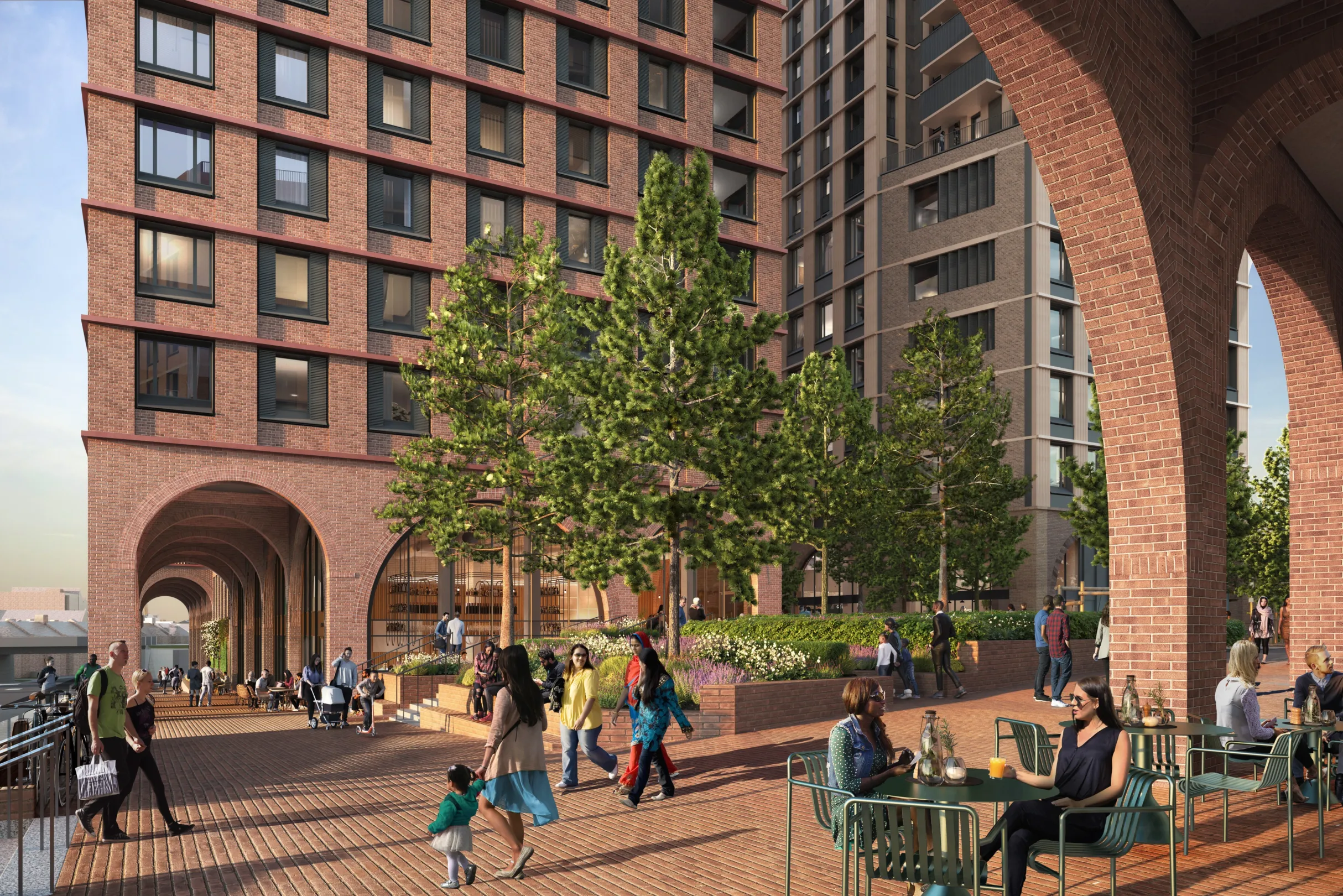 CGI of Multiple large residential buildings surrounding a wide plaza with trees. Cafes occupy commercial space at ground level. and wide brick arches support the buildings and create space and shade for pedestrians.