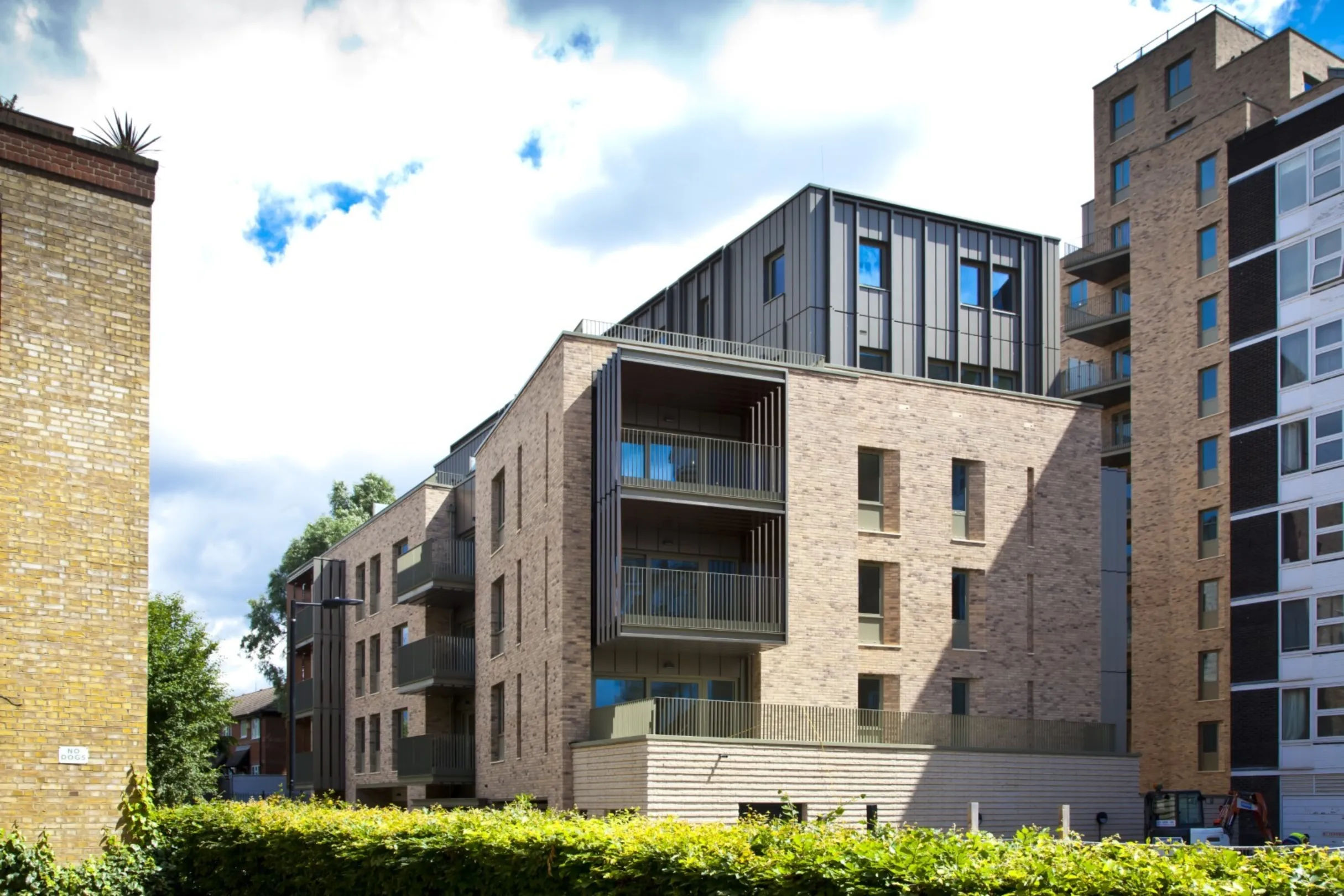 Detail of the lower floors of a modern multi storey residential building on the bank of the River Thames.