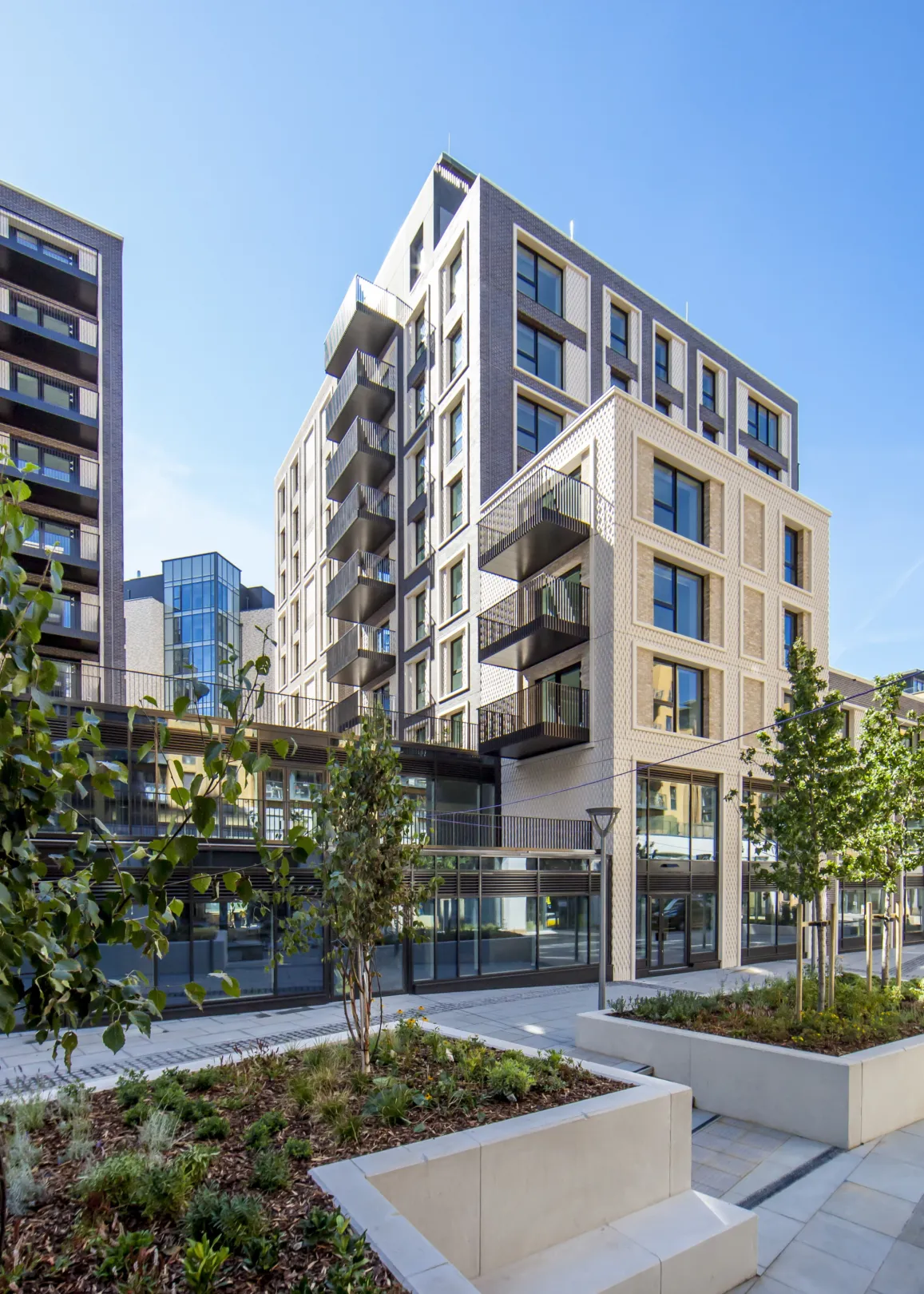 A large residential development, showing planters and benches in a residential communal area
