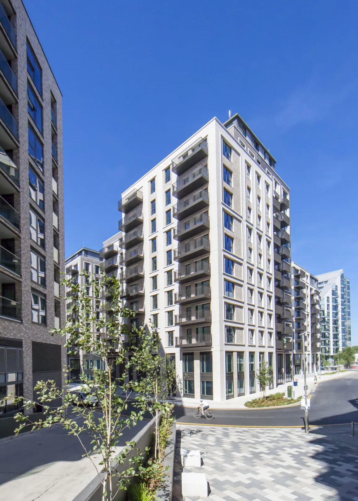 A large residential development, showing planters and benches in a residential communal area