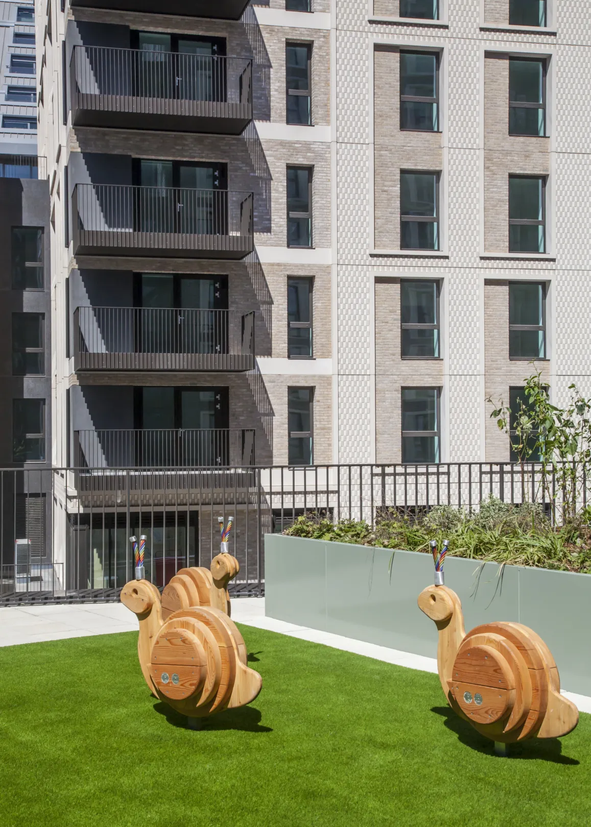 A lawned area in front of a modern residential building