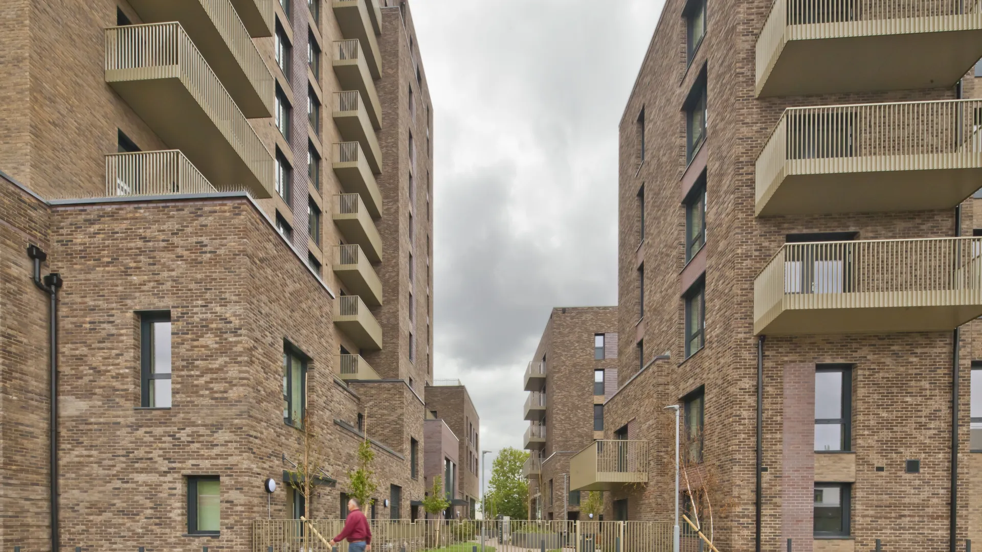 A modern multi storey residential building with balconies on the facade