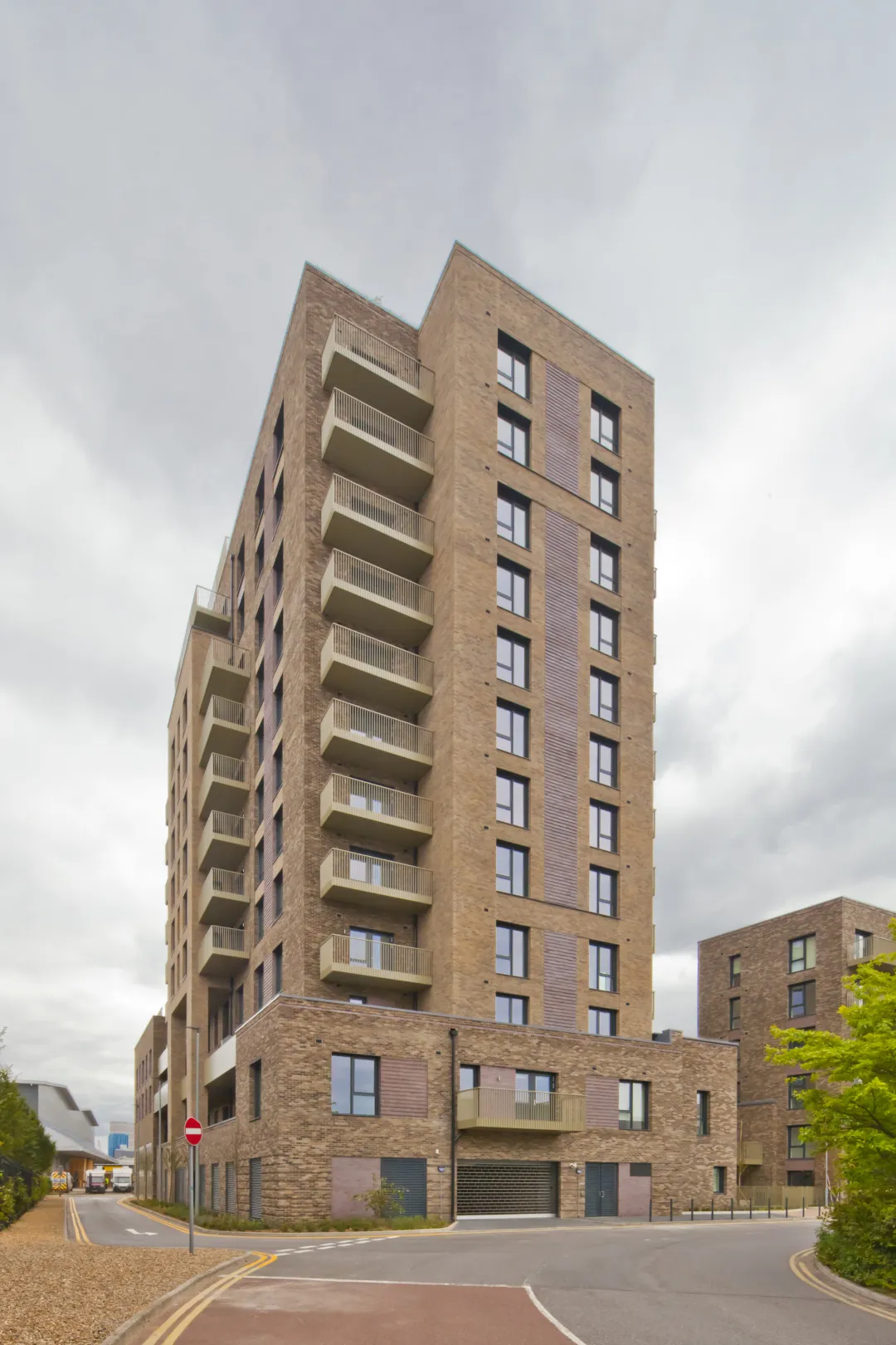 A modern multi storey residential building with balconies on the facade