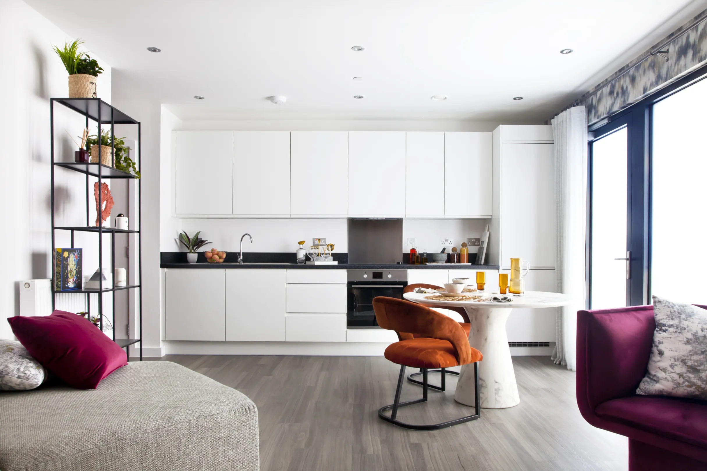 Galley kitchen a modern residential building with floor to ceiling windows and designer furnishings