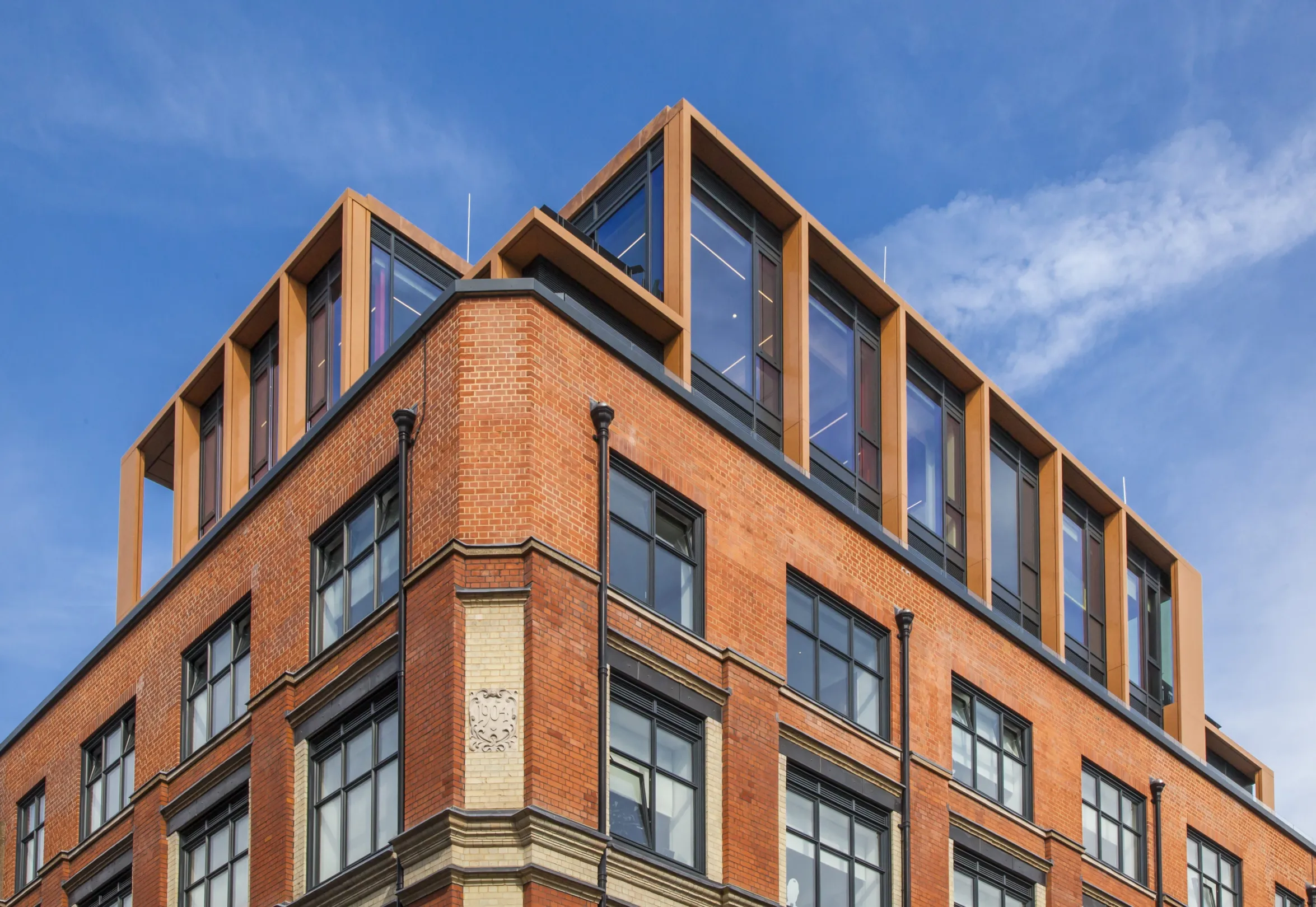 A modern residential block occupying a corner of a London street