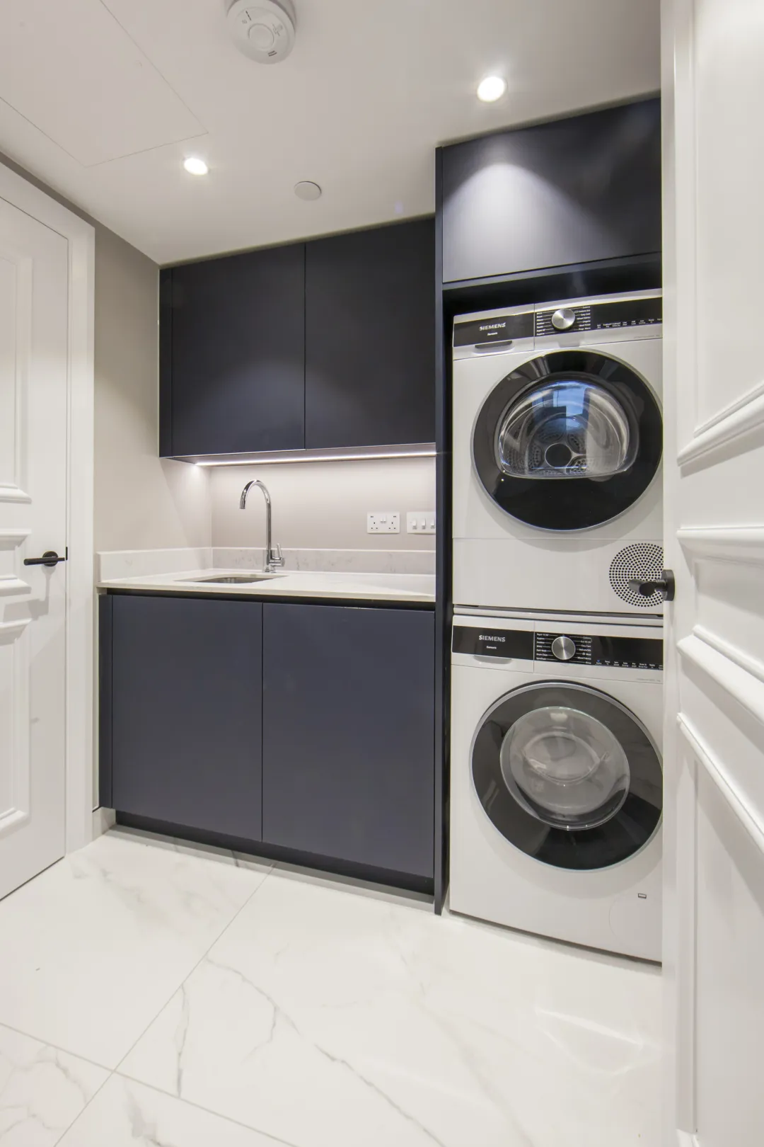 Utility room with washing machine and tumble dryer