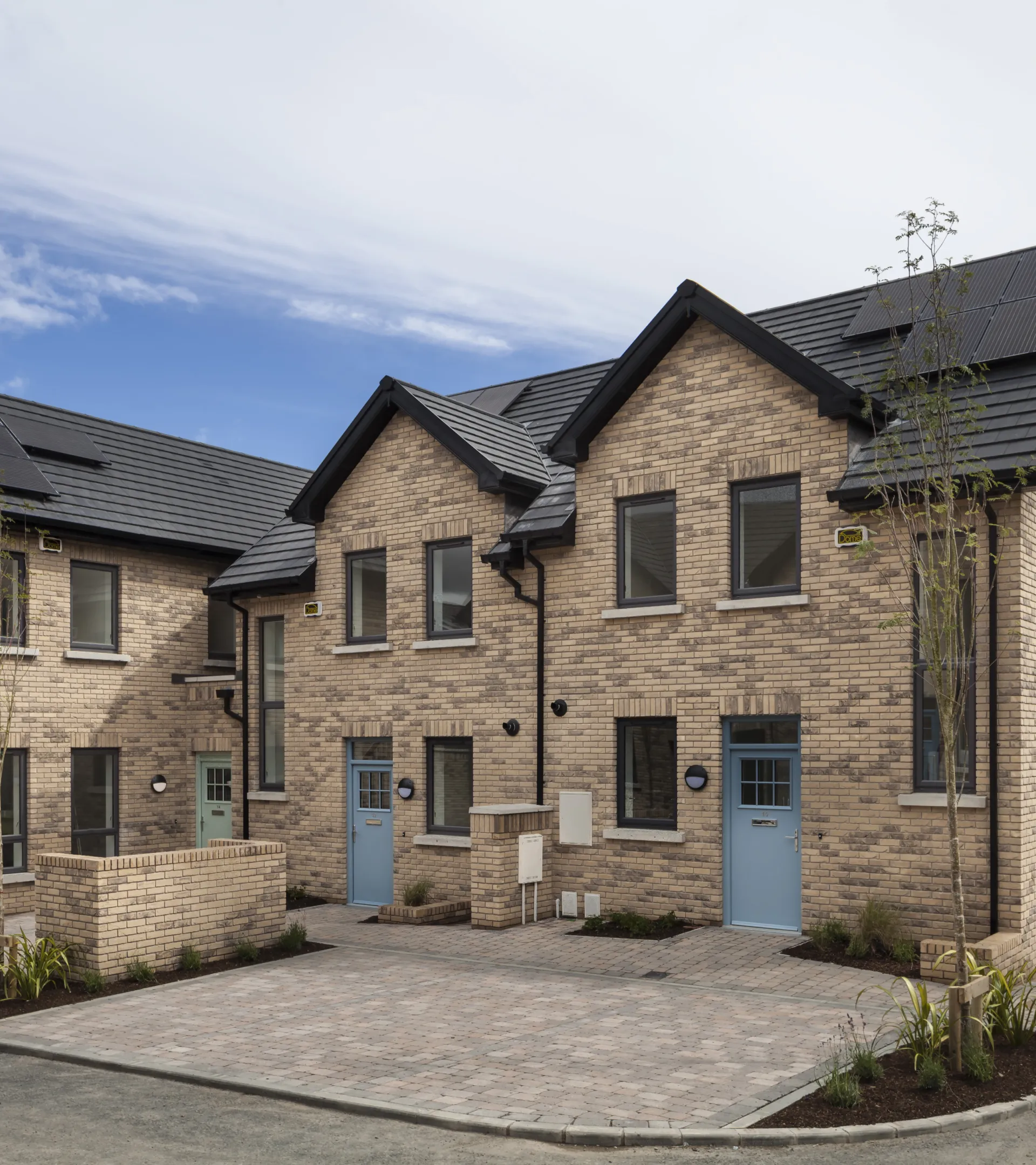 Modern houses with pitched roofs and blue front doors