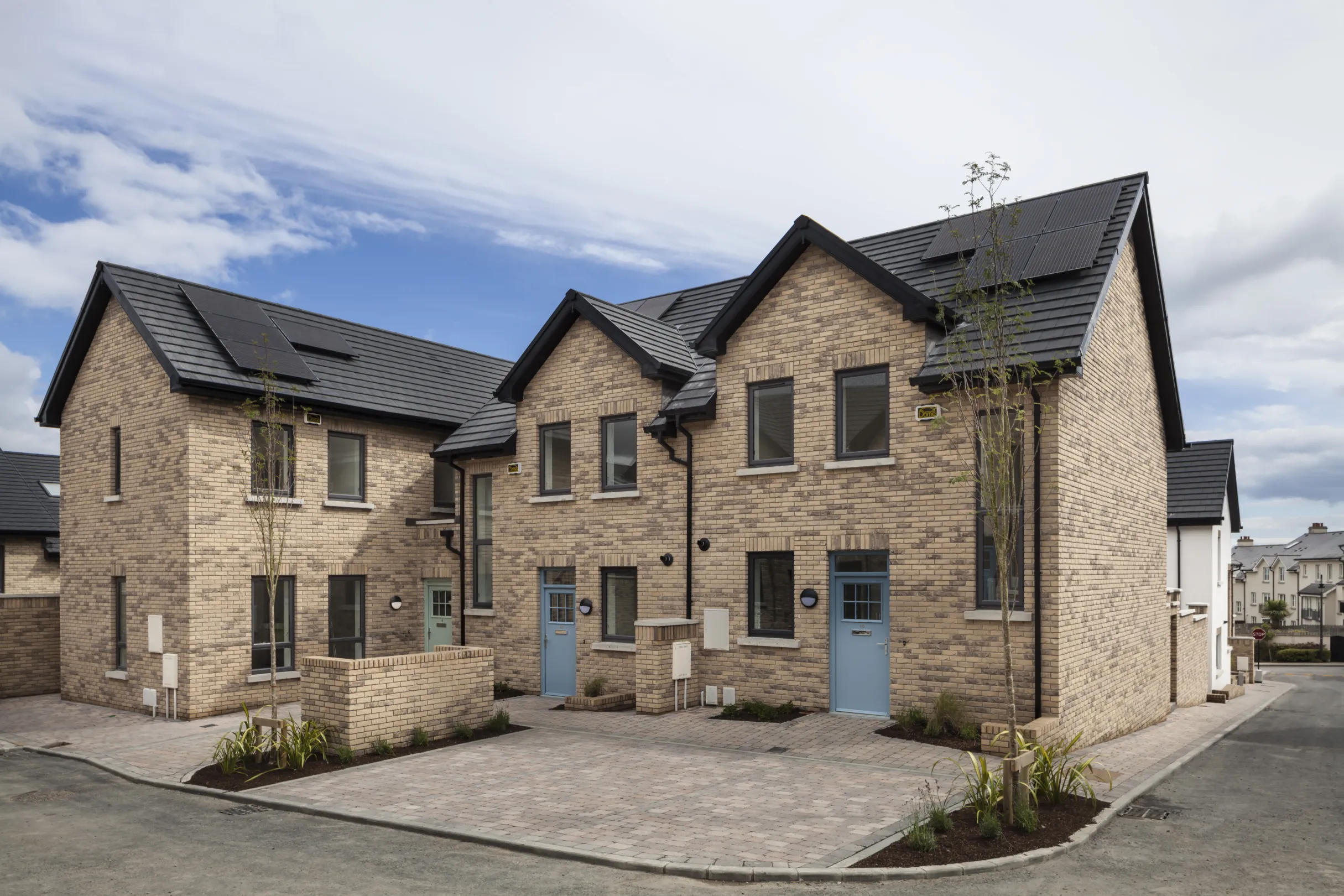 Modern houses with pitched roofs and blue front doors
