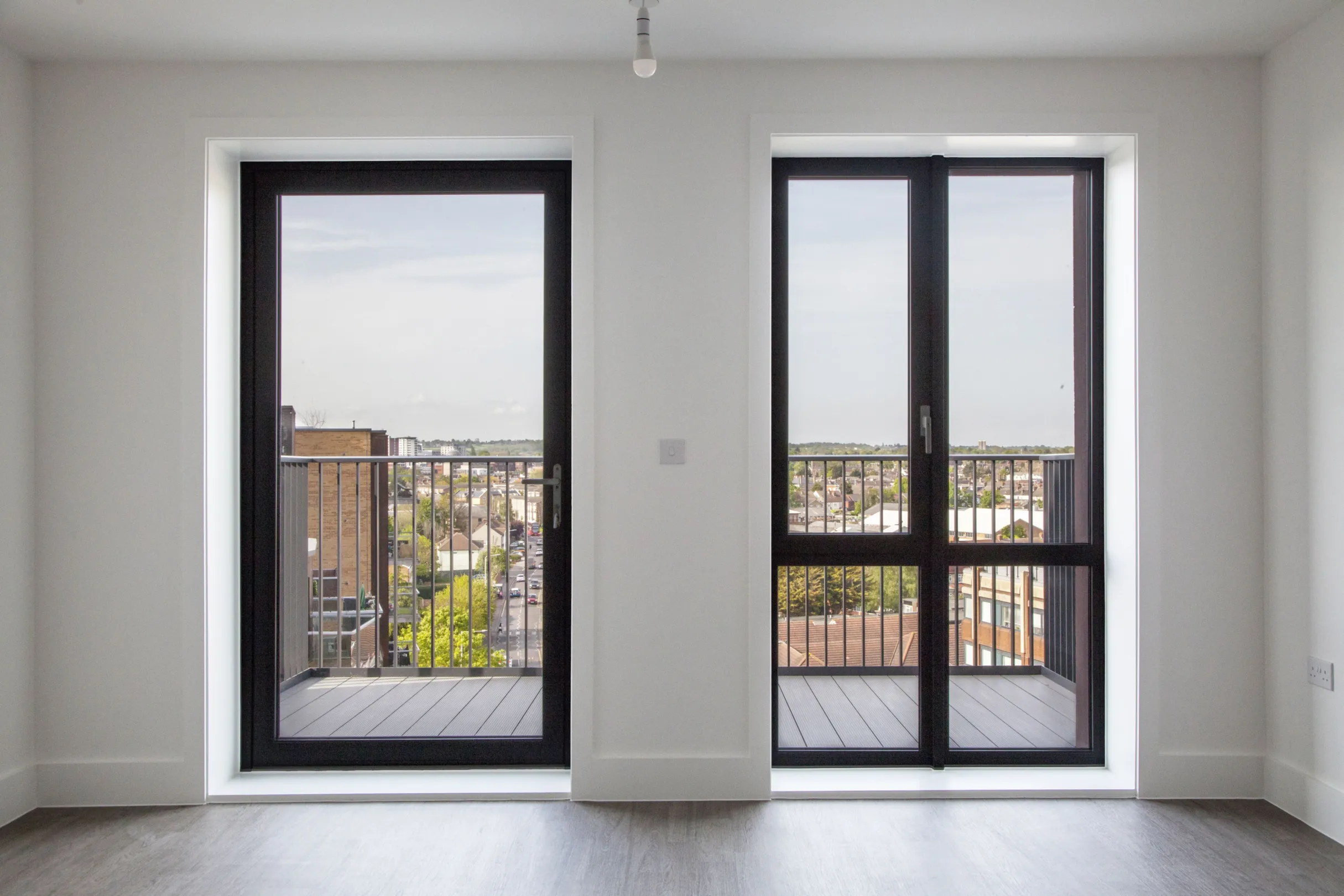 modern interior living space showing glazed windows and looks looking out to a balcony
