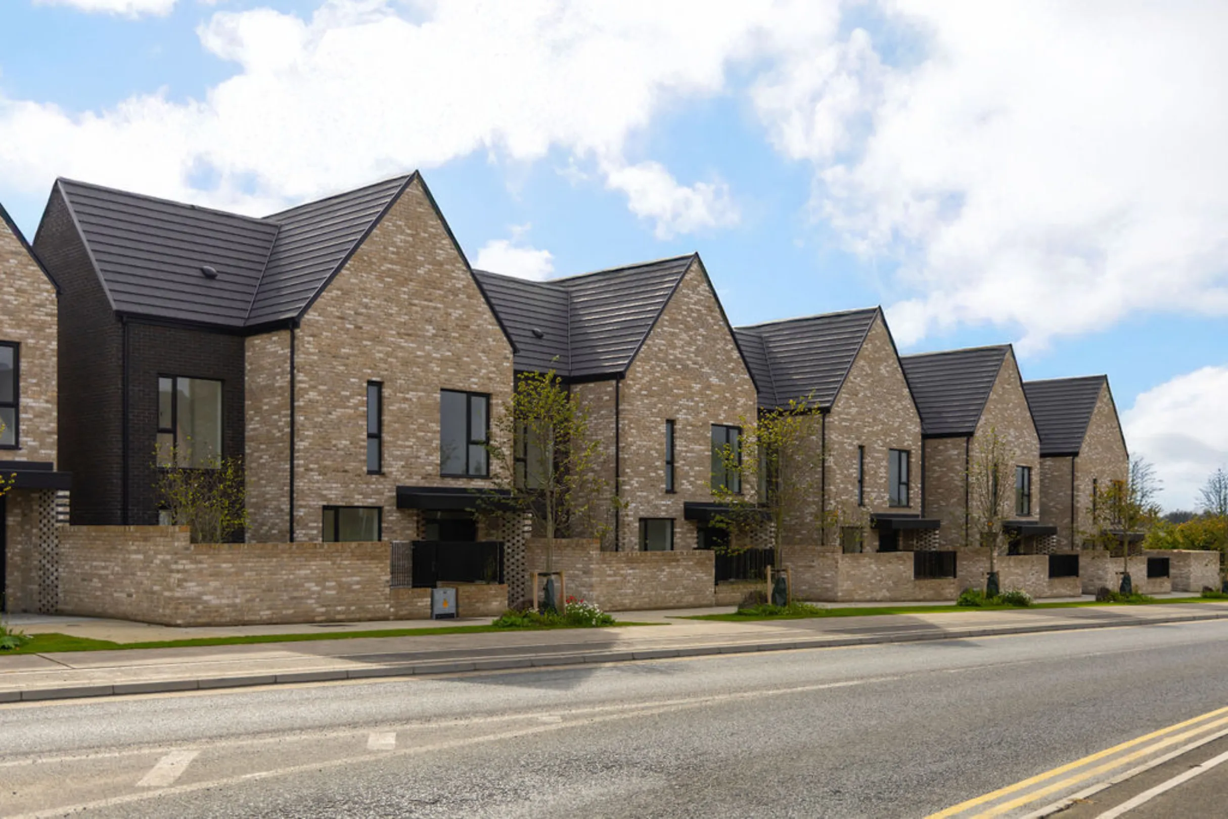 Row of yellow brick houses fronting the main road in Sand Wood, Portlaoise