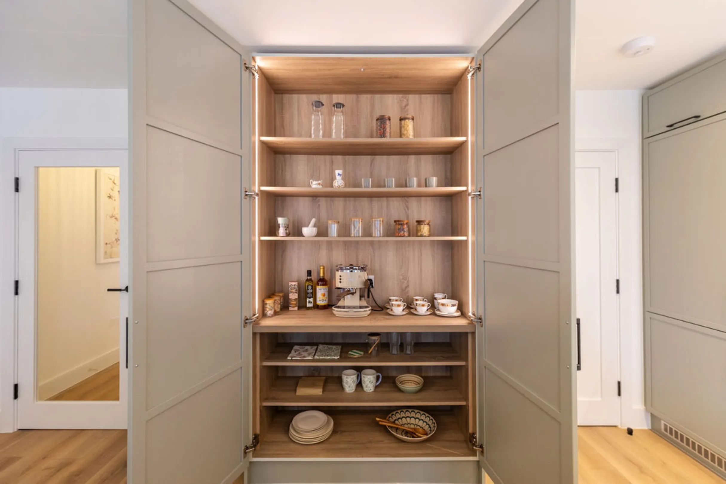 The image showcases a modern kitchen with a pantry unit