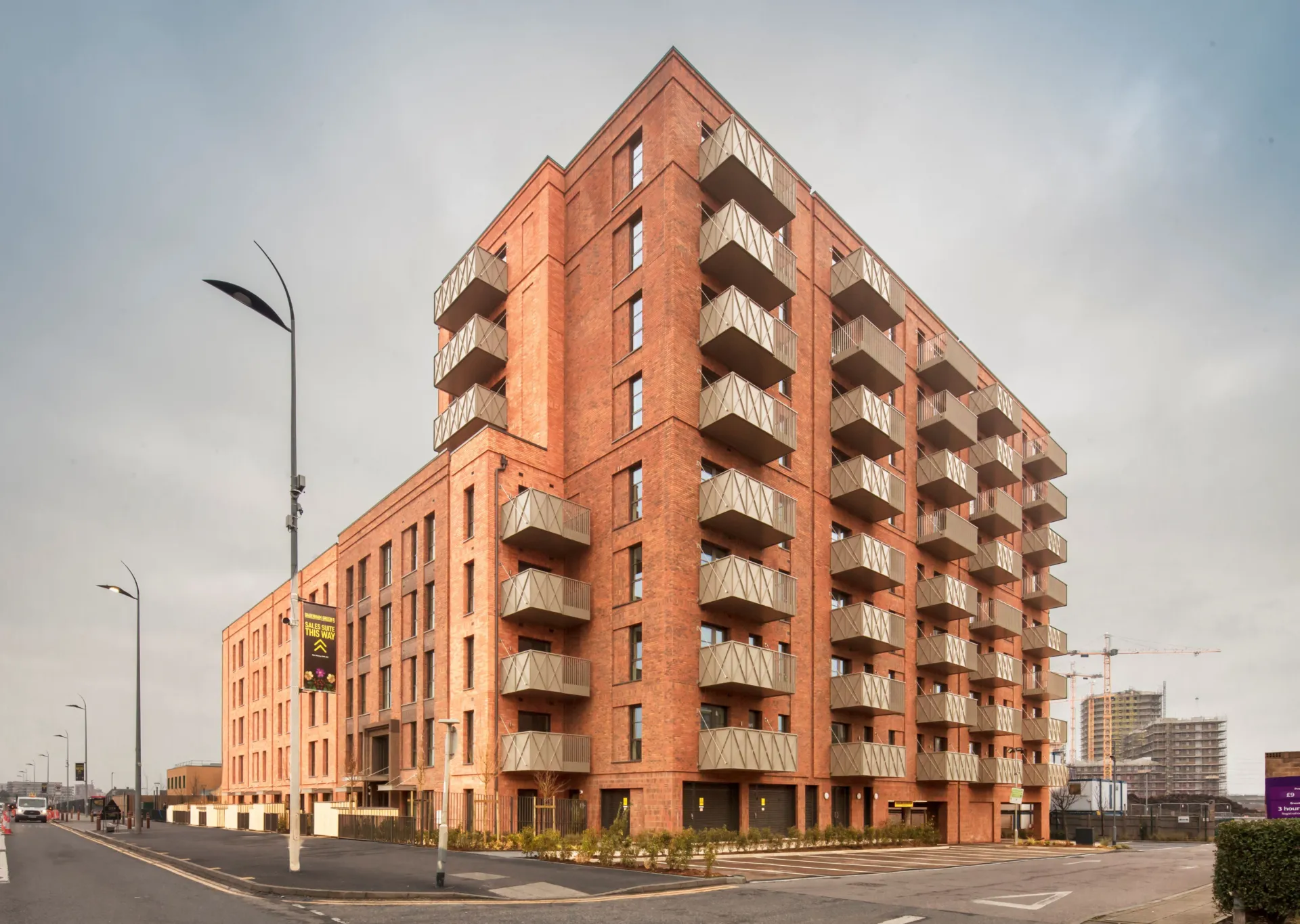 A new build red brick building with green roofs in Dagenham