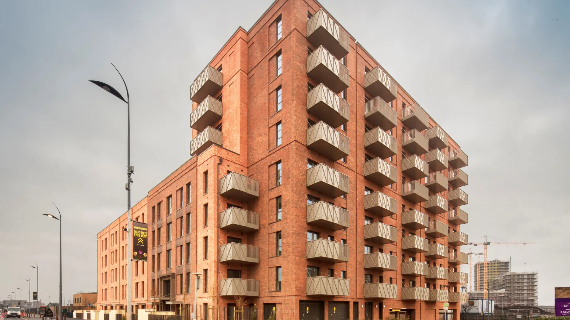 A new build red brick building with green roofs in Dagenham