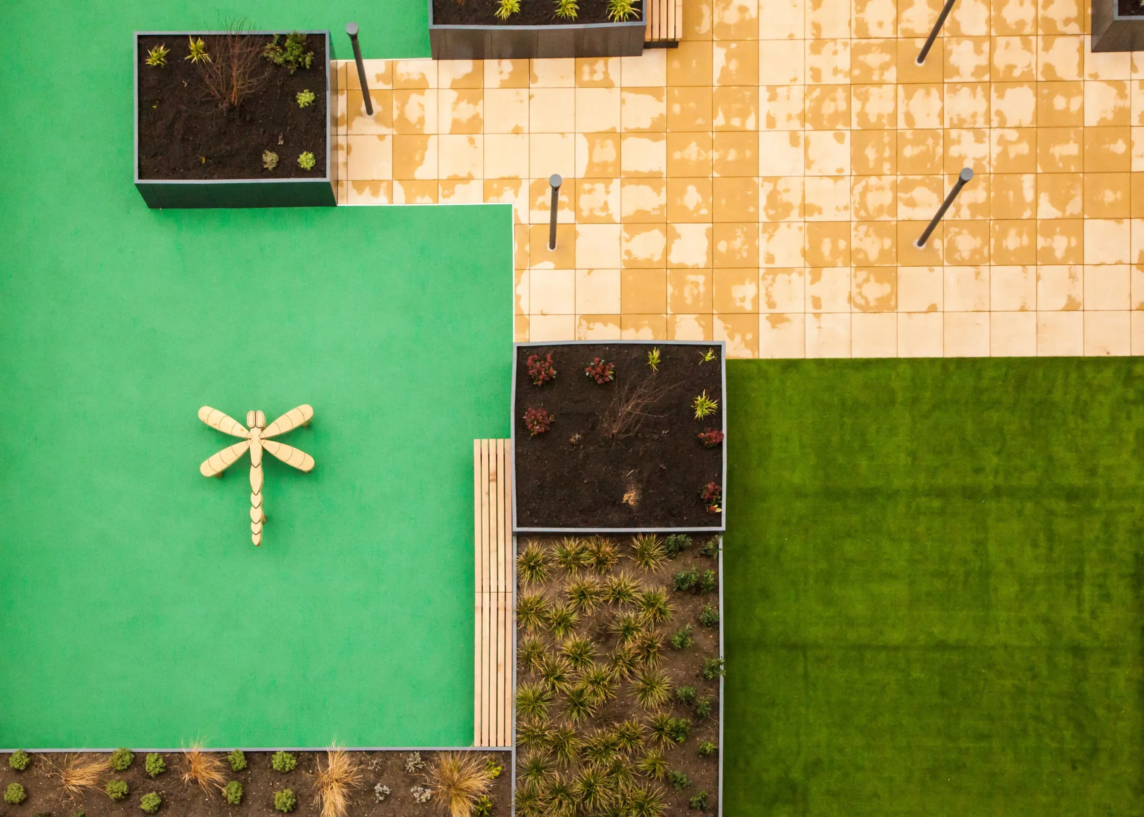 A new build red brick building with green roofs in Dagenham