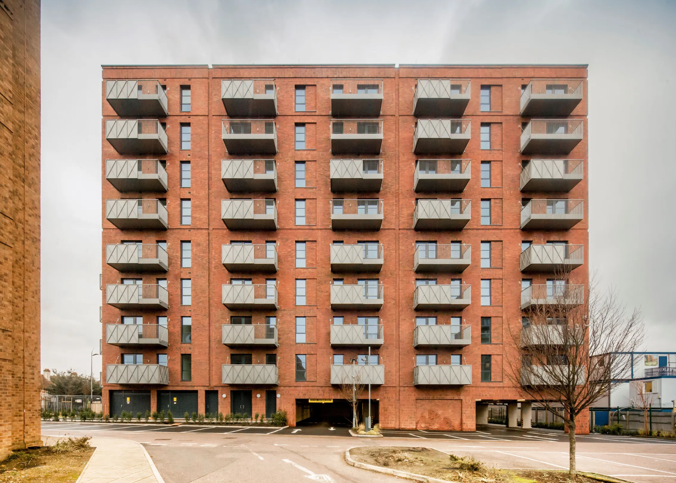 A new build red brick building with green roofs in Dagenham