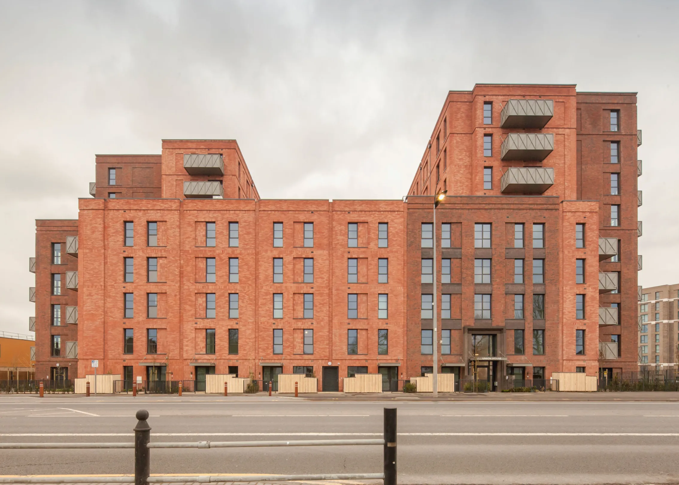 A new build red brick building with green roofs in Dagenham