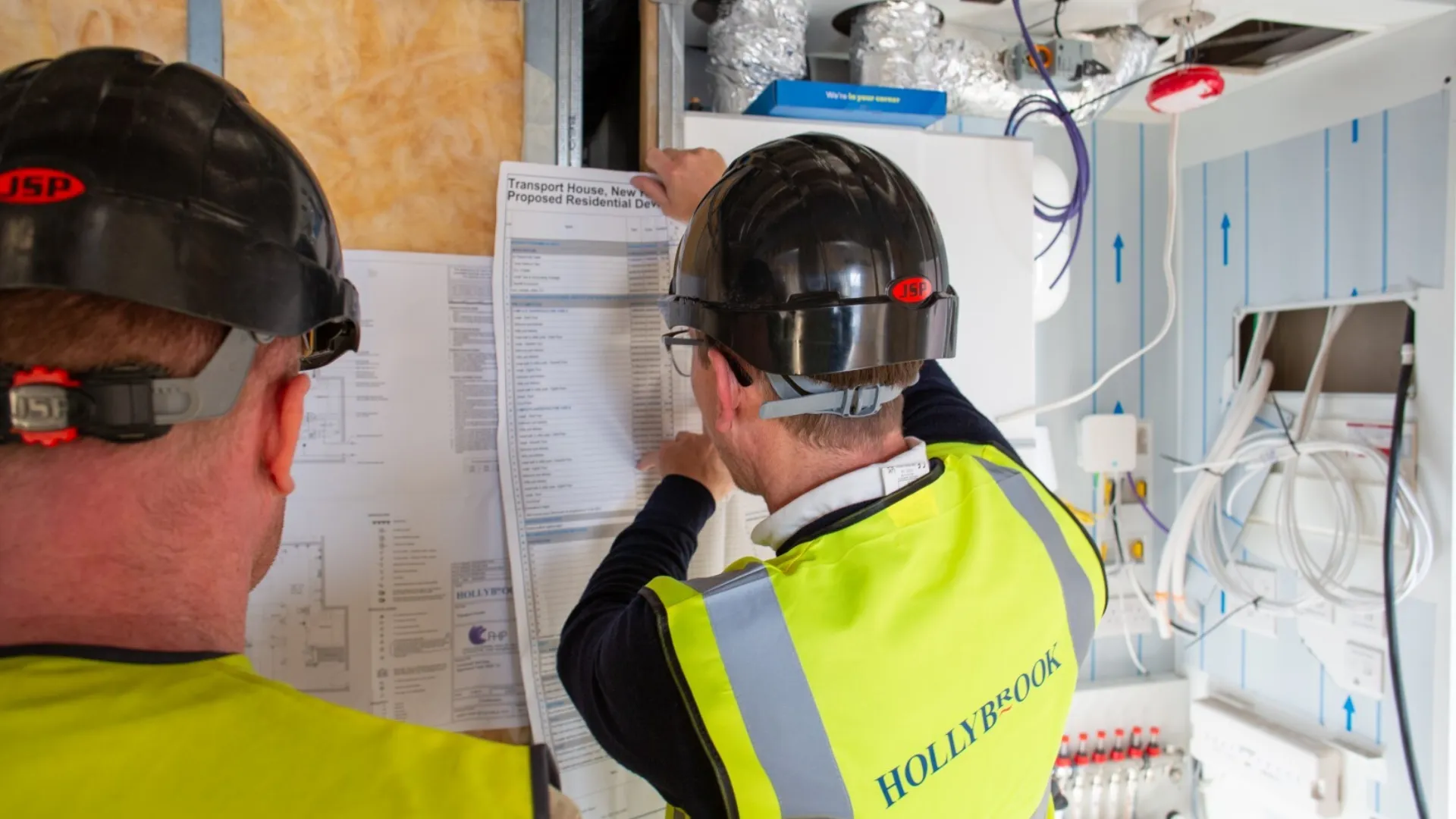 Hollybrook operative on site looking at a construction programme