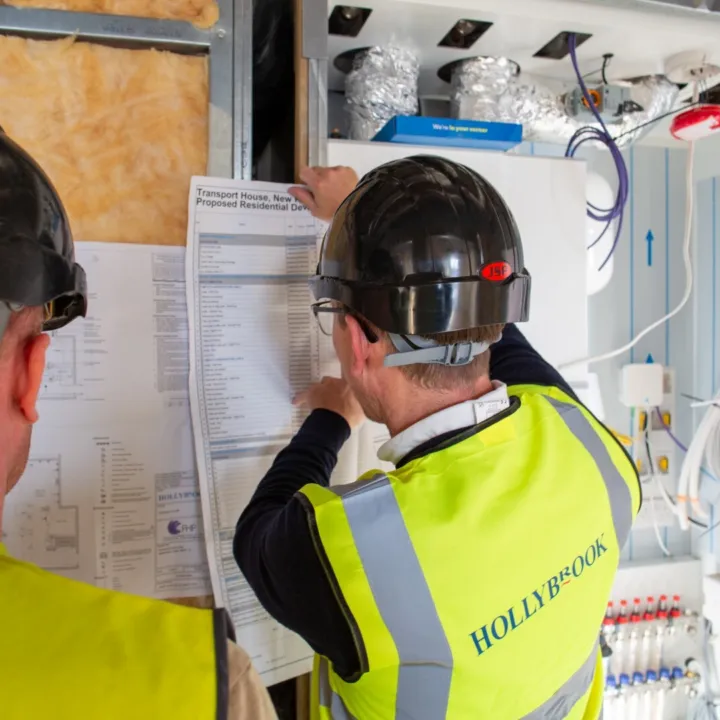 Hollybrook operative on site looking at a construction programme