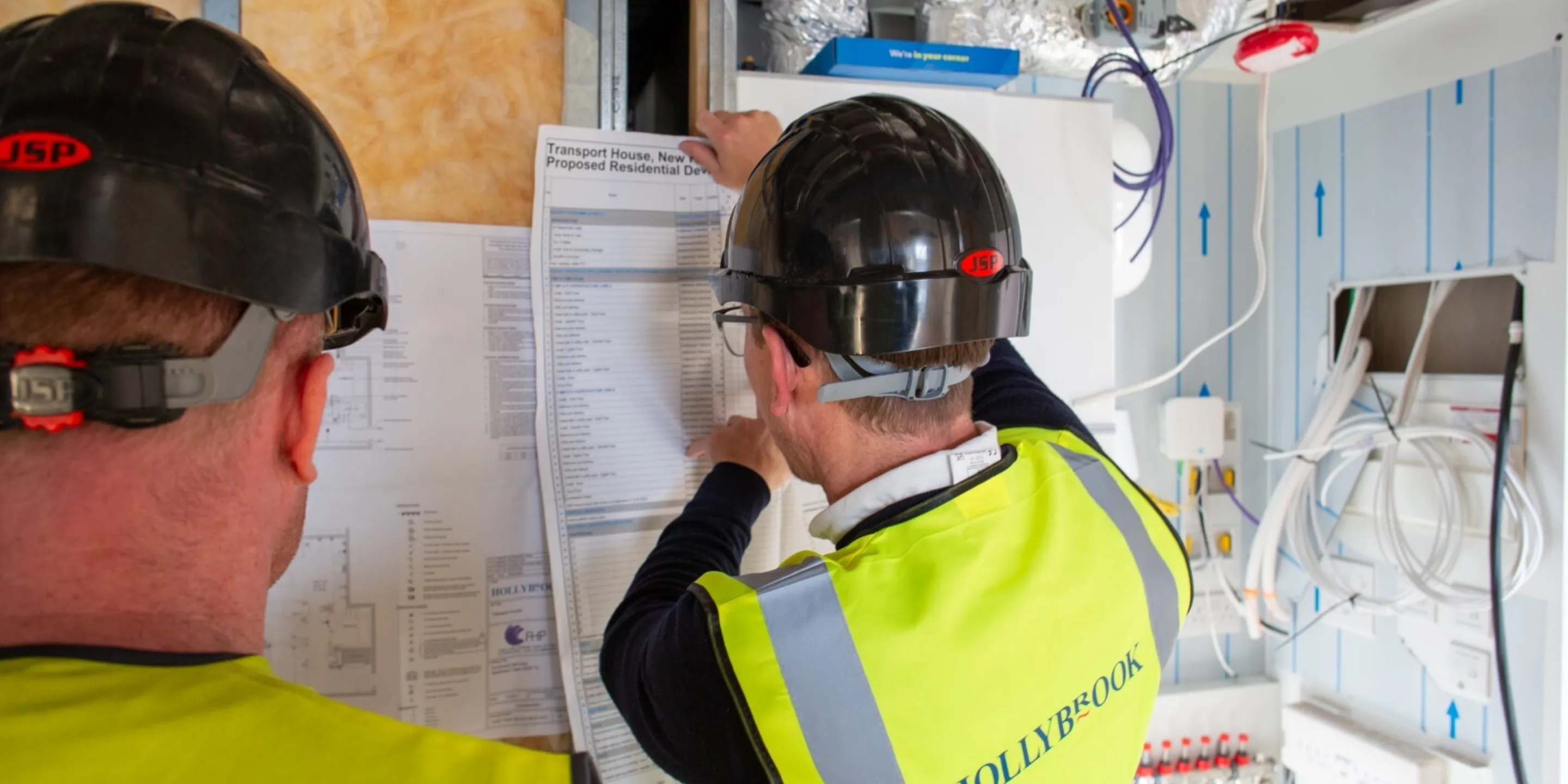 Hollybrook operative on site looking at a construction programme